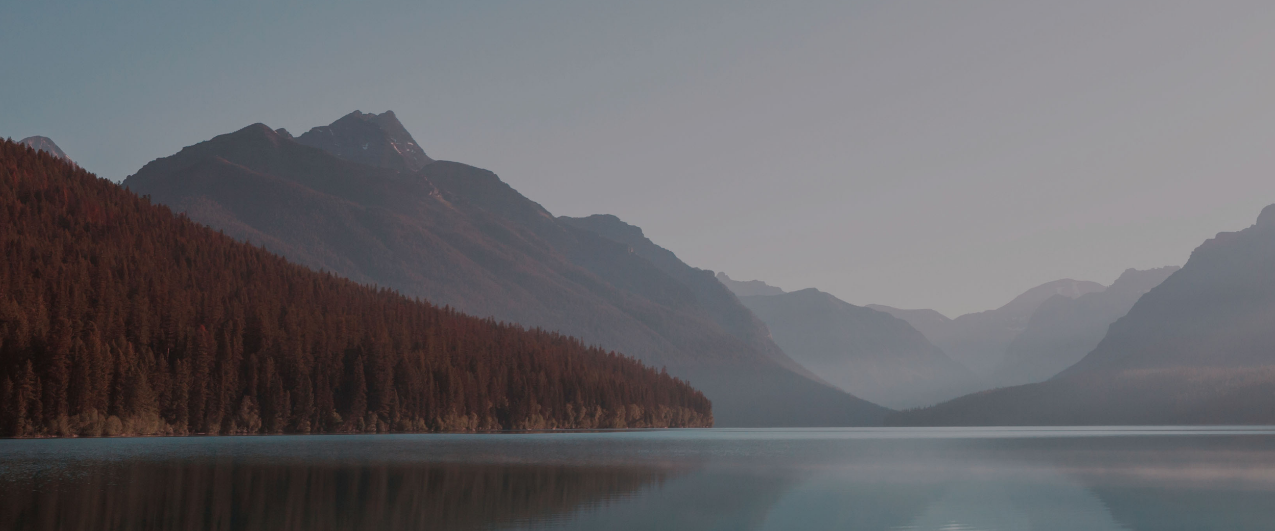 Image of the mountains a body of water at their base