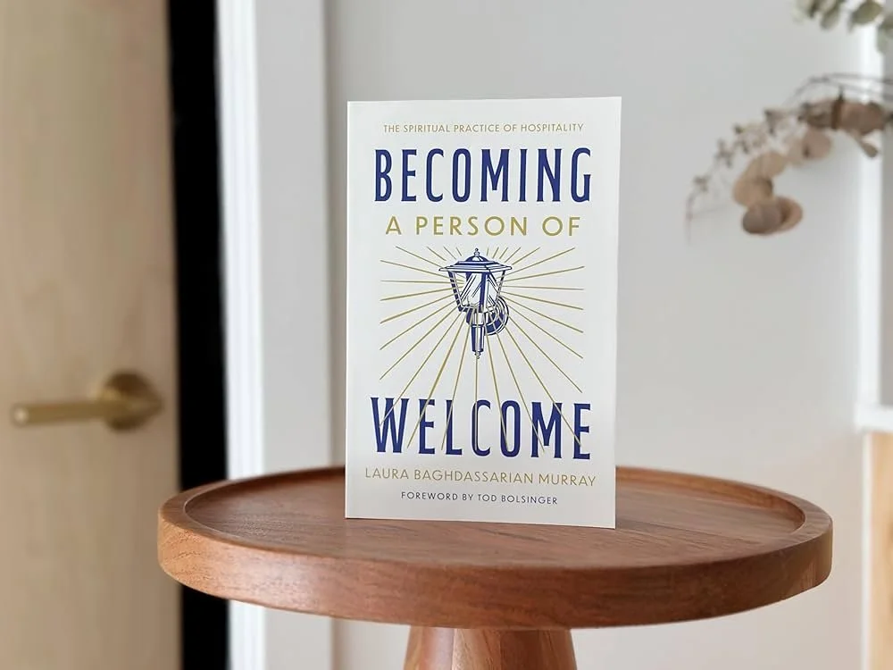 Image of Becoming a Person of Welcome book on a table