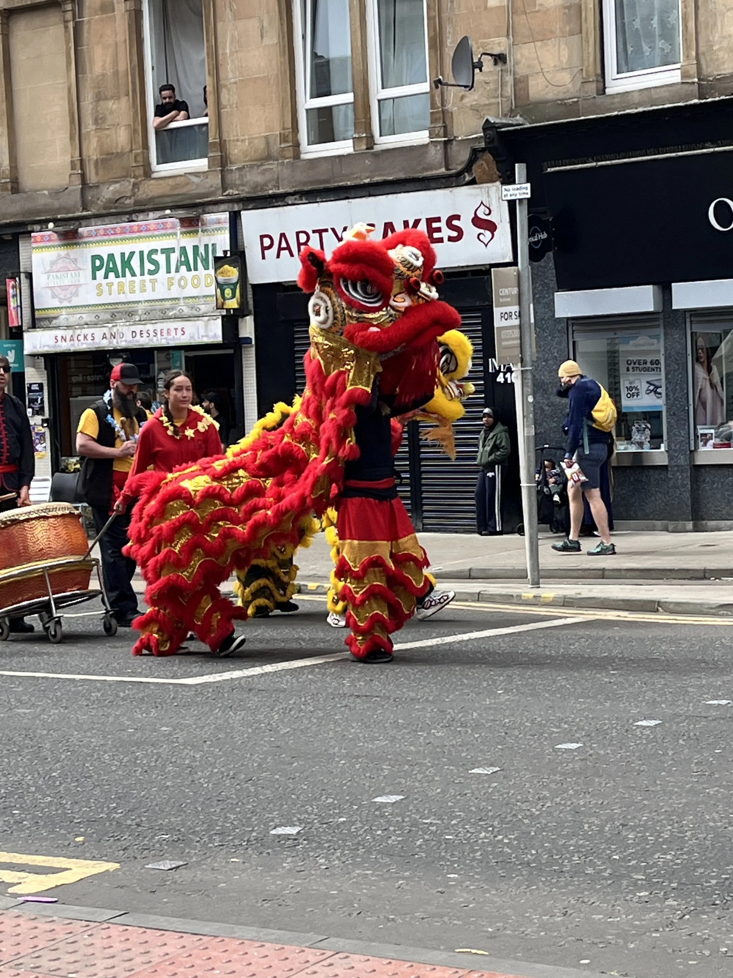 A large red dragon on a city street