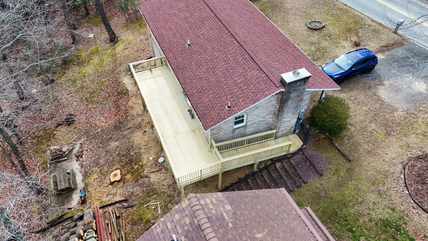 Aerial view of elevated deck construction by a deck contractor in Laurel, MD on a sloped backyard
