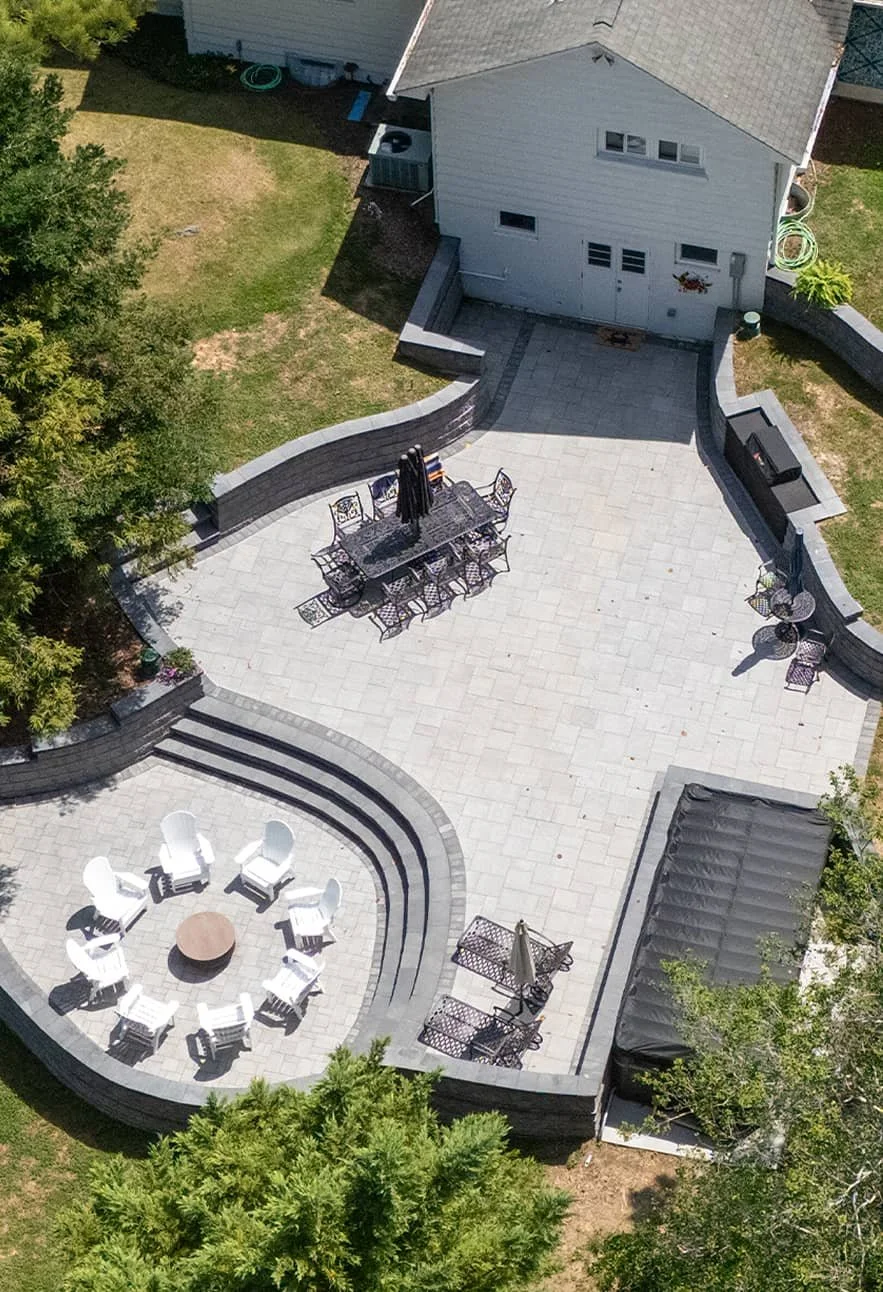 Outdoor living space with tiered patio and seating areas designed for entertaining in Laurel, MD