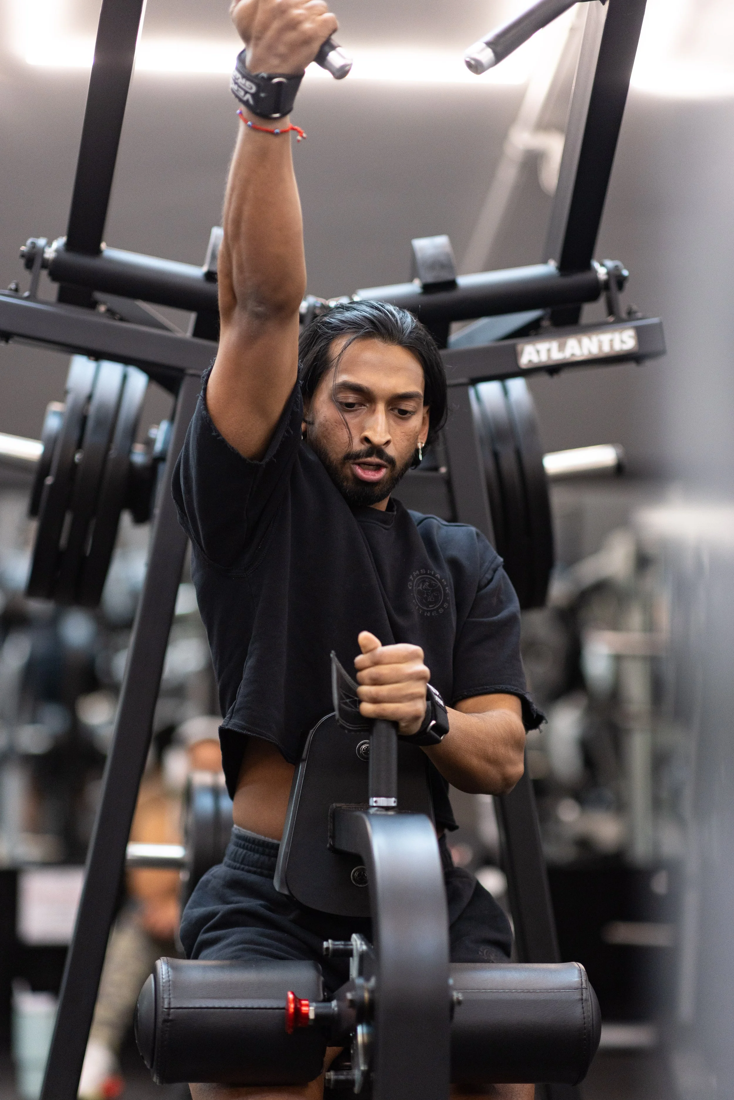 Man exercising on a rowing machine at the gym.