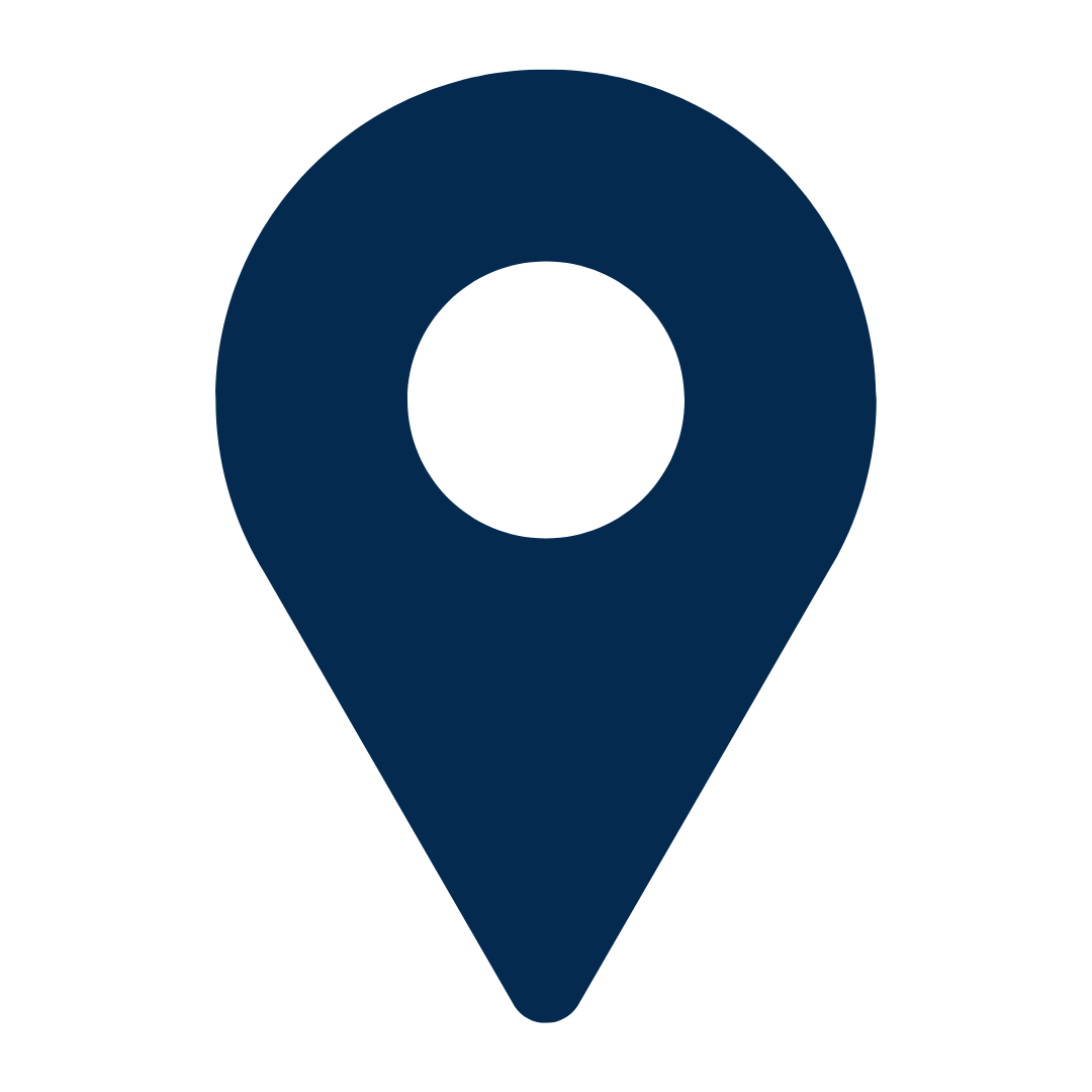 A dark blue map pin icon with a black circle in the center.