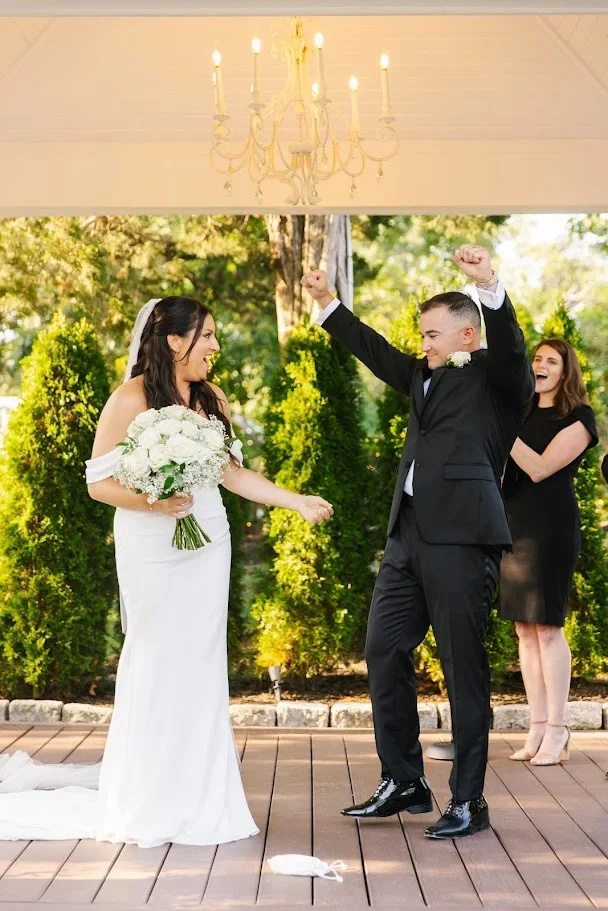 Wedding officiant celebrating with Aimee and John after their glass-breaking ceremony at the River Club in Scituate, Massachusetts