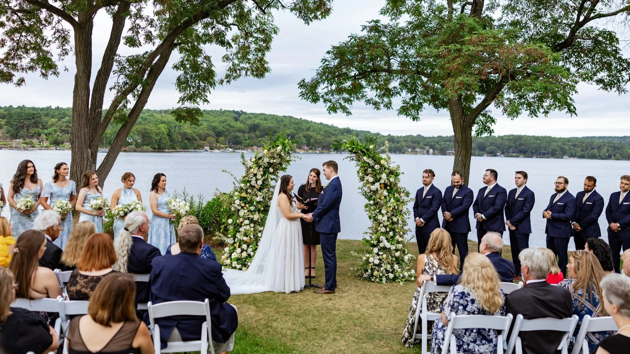Wedding officiant leading a lakeside ceremony at Church Landing on Lake Winnipesaukee in Meredith, New Hampshire
