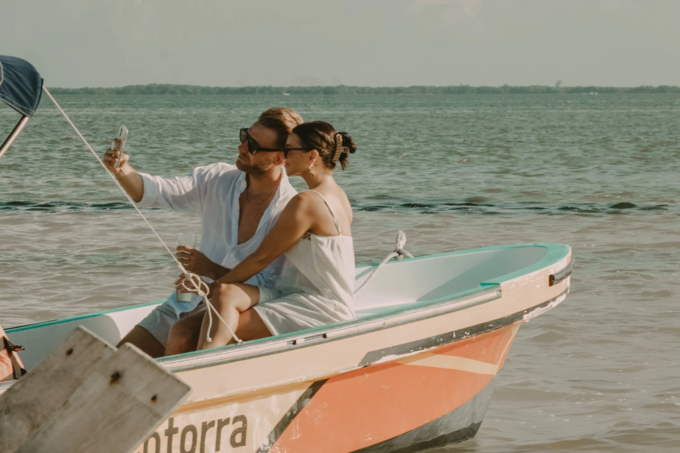 Couple enjoying a private boat ride together in the waters of Holbox.