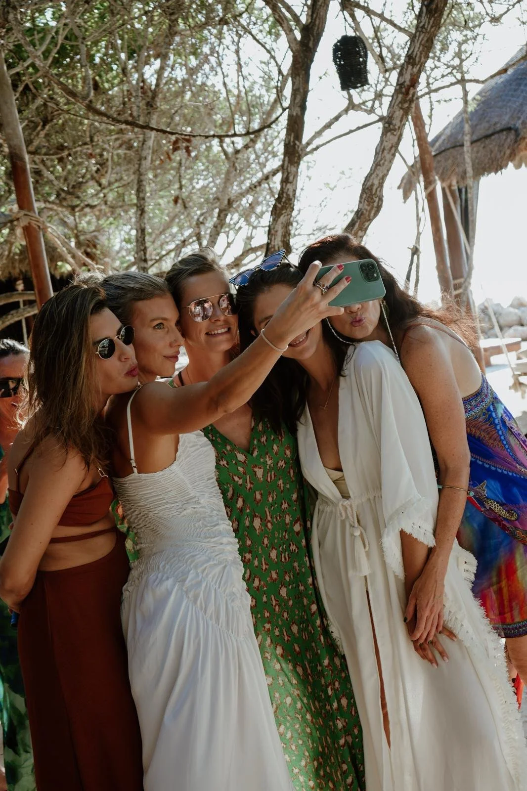 Group of friends taking a selfie during a beach celebration in Holbox.