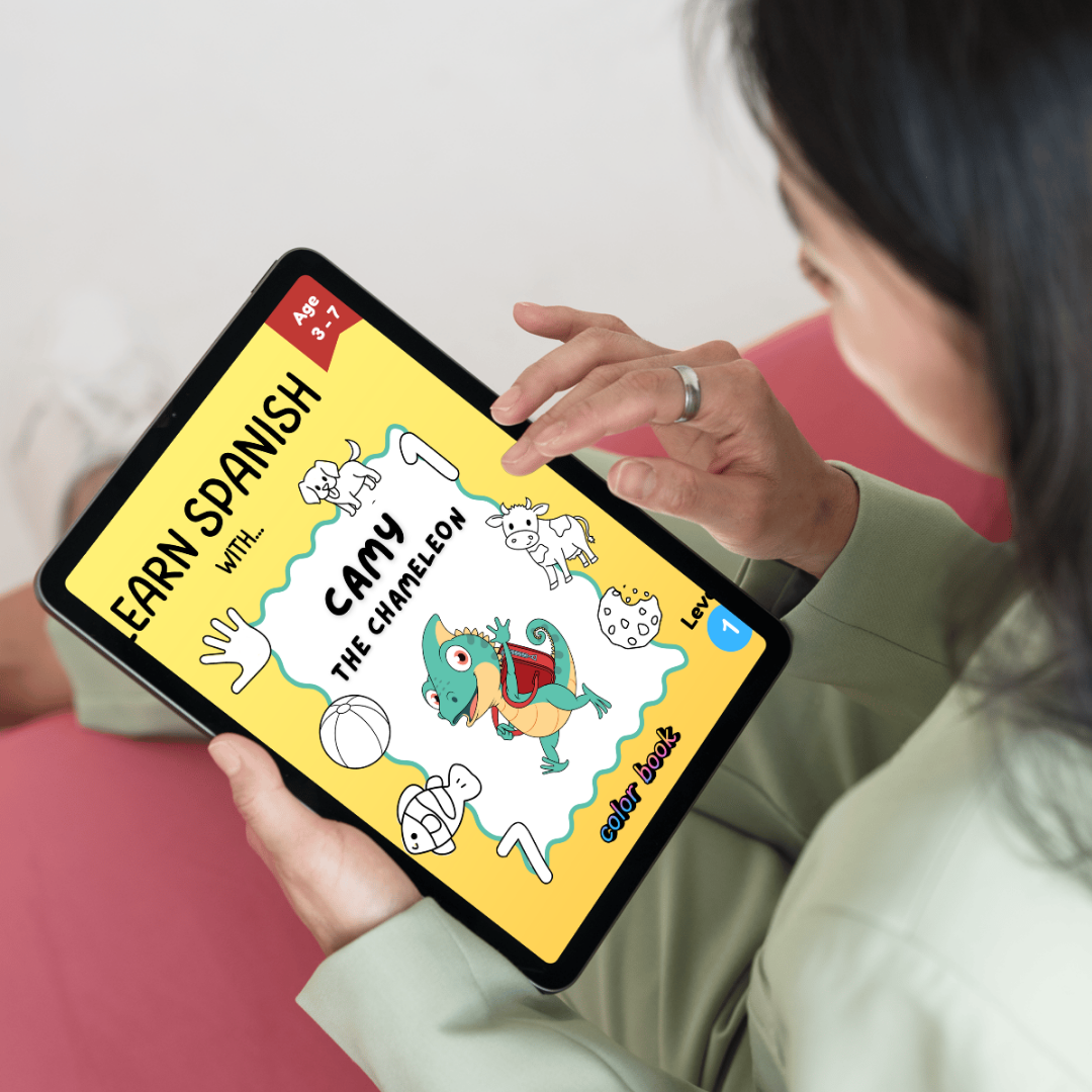 A toddler holding a tablet displaying a children's educational app called 'Early Spanish with Camy the Chameleon'. The app features cartoon animals, colorful text, and a level indicator, designed for children aged 3 to 7.