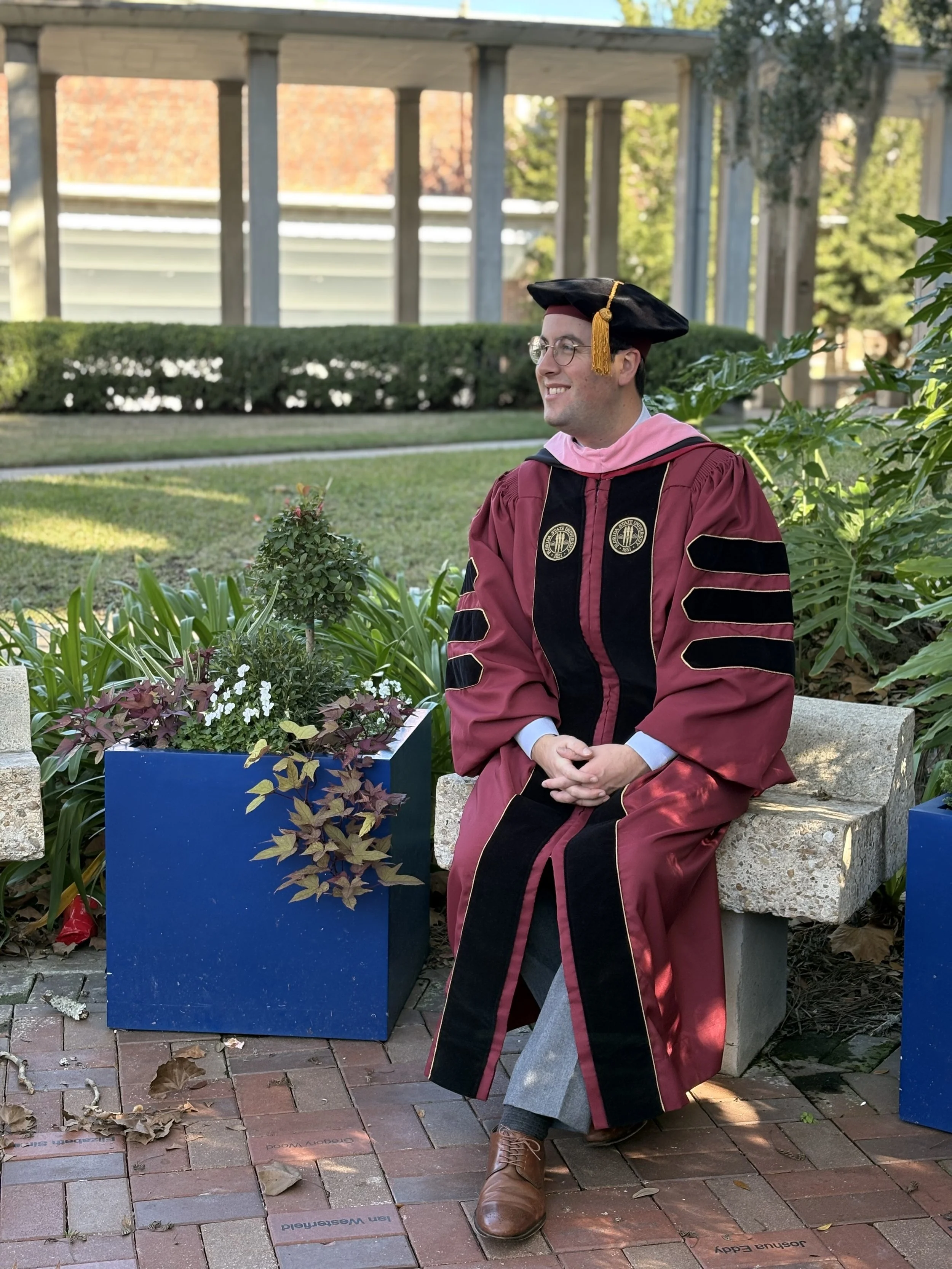 Connor in his doctoral regailia in a garden