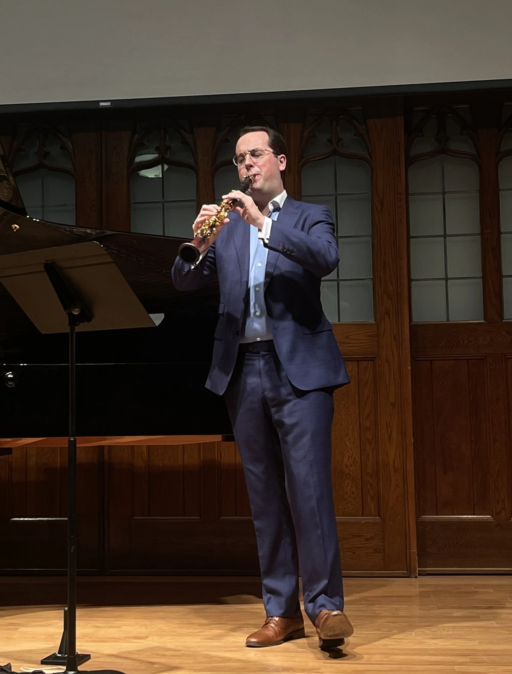 Connor performing in a recital in a blue suit