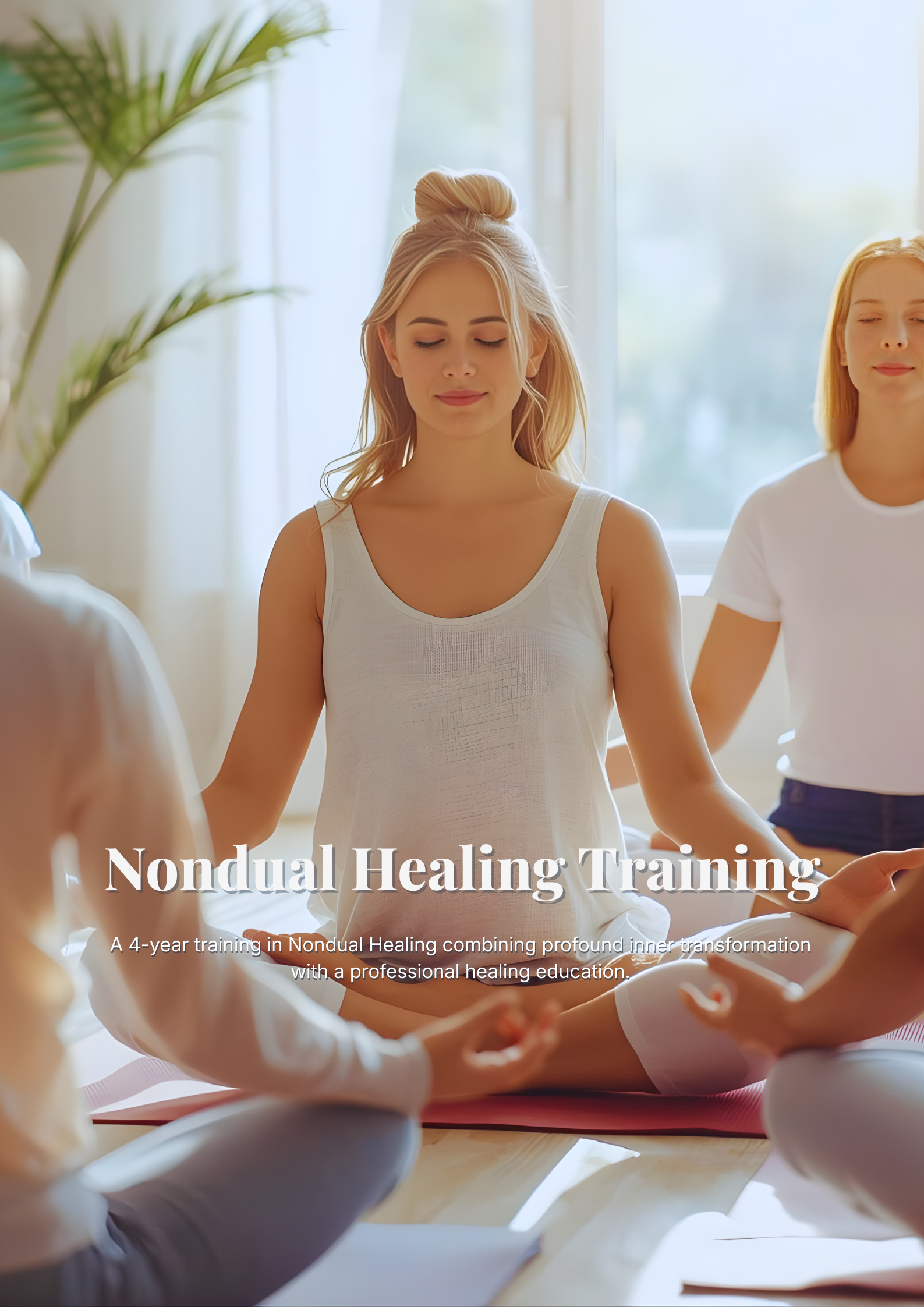 A group of people practicing mindful meditation in a bright, sunlit room. A young woman with blonde hair in a top knot sits in the center in a cross-legged lotus pose, wearing a white tank top with her eyes closed in a peaceful expression.