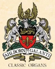 A coat of arms featuring two white unicorns supporting a shield with a fleur-de-lis, a crest with a bird, and a banner reading 'Ahlborn Galanti Classic Organs'.
