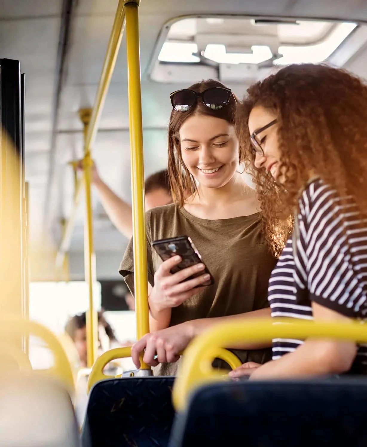 two woman smiling on public transit in Denver, Colorado