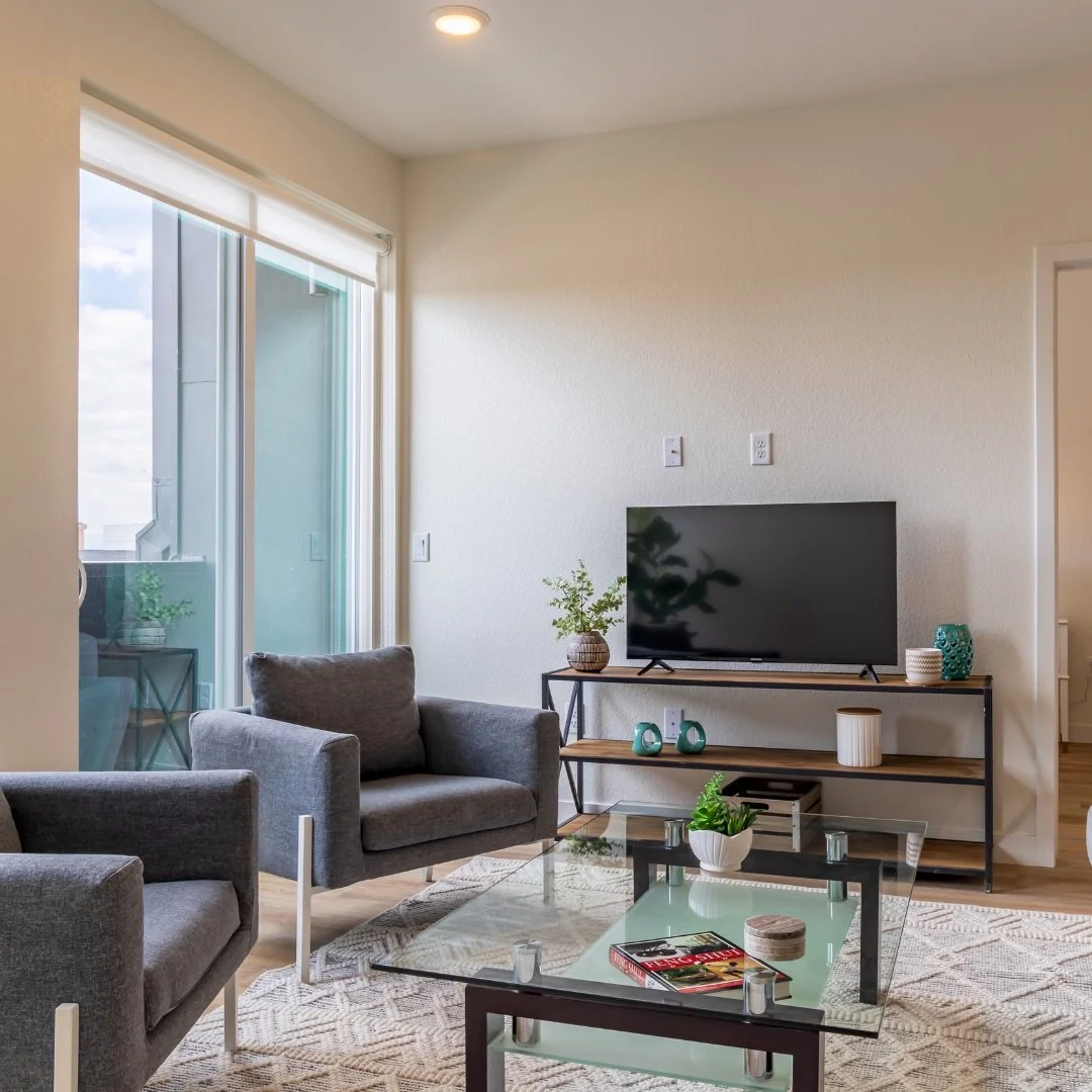 A cozy living room setup featuring comfortable chairs, a coffee table, and a TV for relaxation and entertainment.