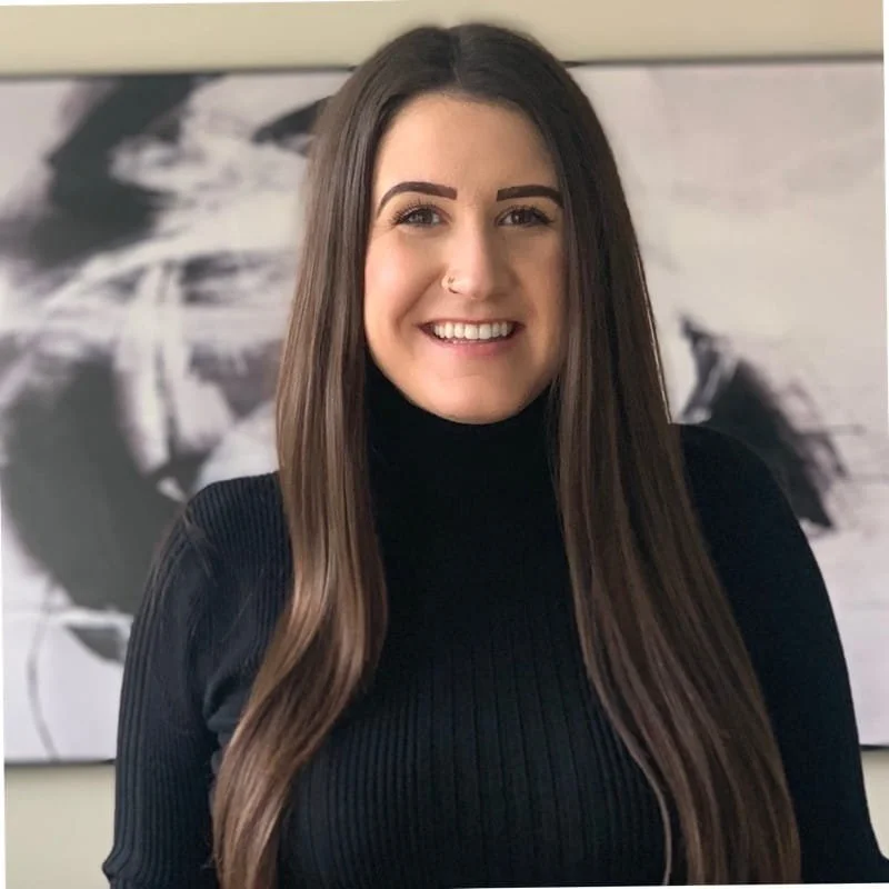 Image of Kelsie Johnson, LMFT, a therapist at Can We Meet Therapy. She is smiling, has long brown hair, and is wearing a black turtleneck.