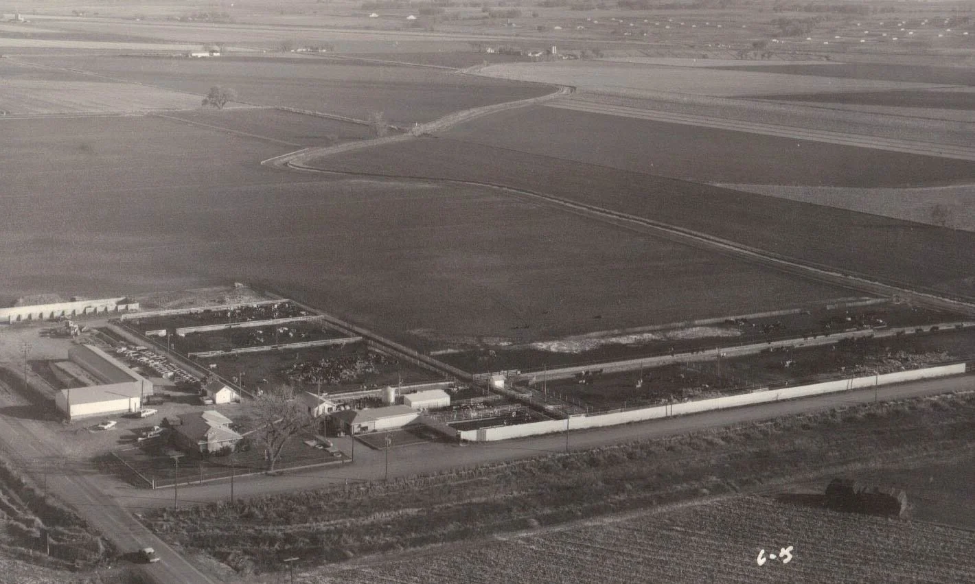Historic photo of a private event venue with aerial view of a rural Colorado farm with fields, buildings, and surrounding roads.