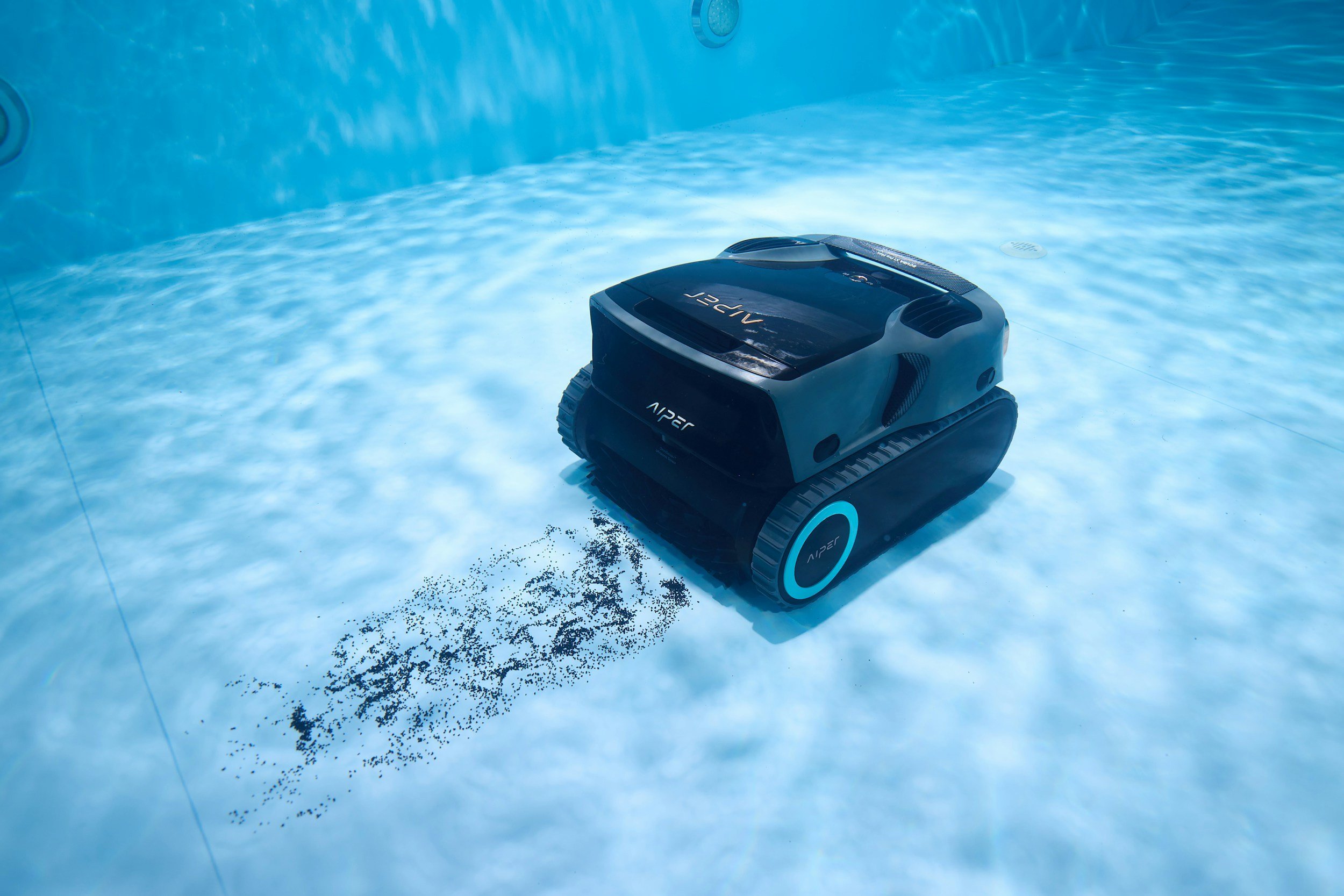 A robotic pool cleaner with the brand name 'AIPER' operating in a swimming pool, cleaning the pool's floor.