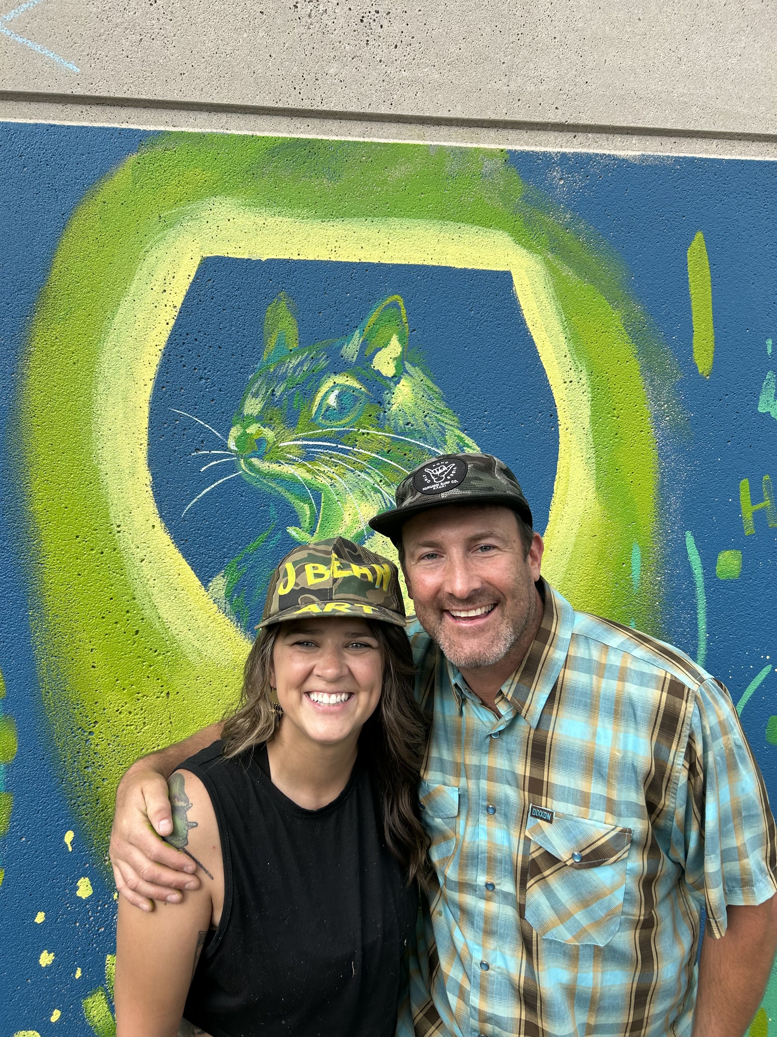 Finished product of Jess teaching a New Belgium Brewing employee how to paint a squirrel (the unofficial NBB mascot) in a goblet. This was the base layer of a mural for the NBB employee retreat made by Fort Collins Mural Project and designed by Chels