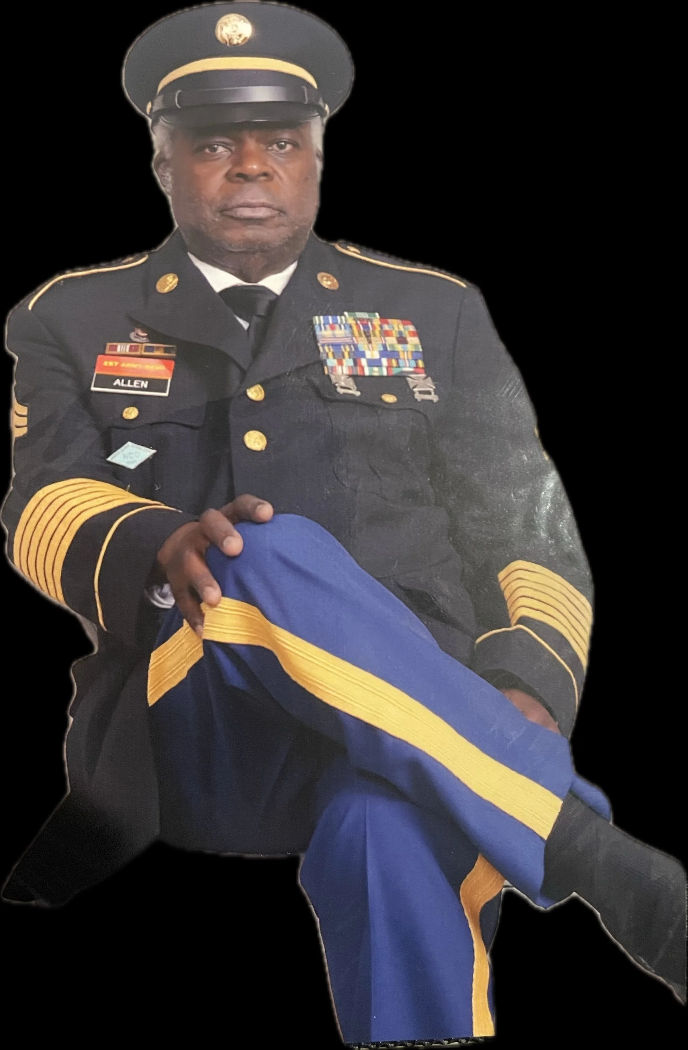 A man dressed in a formal military uniform holding a blue and yellow flag, with medals and ribbons on his chest, and wearing a peaked cap.