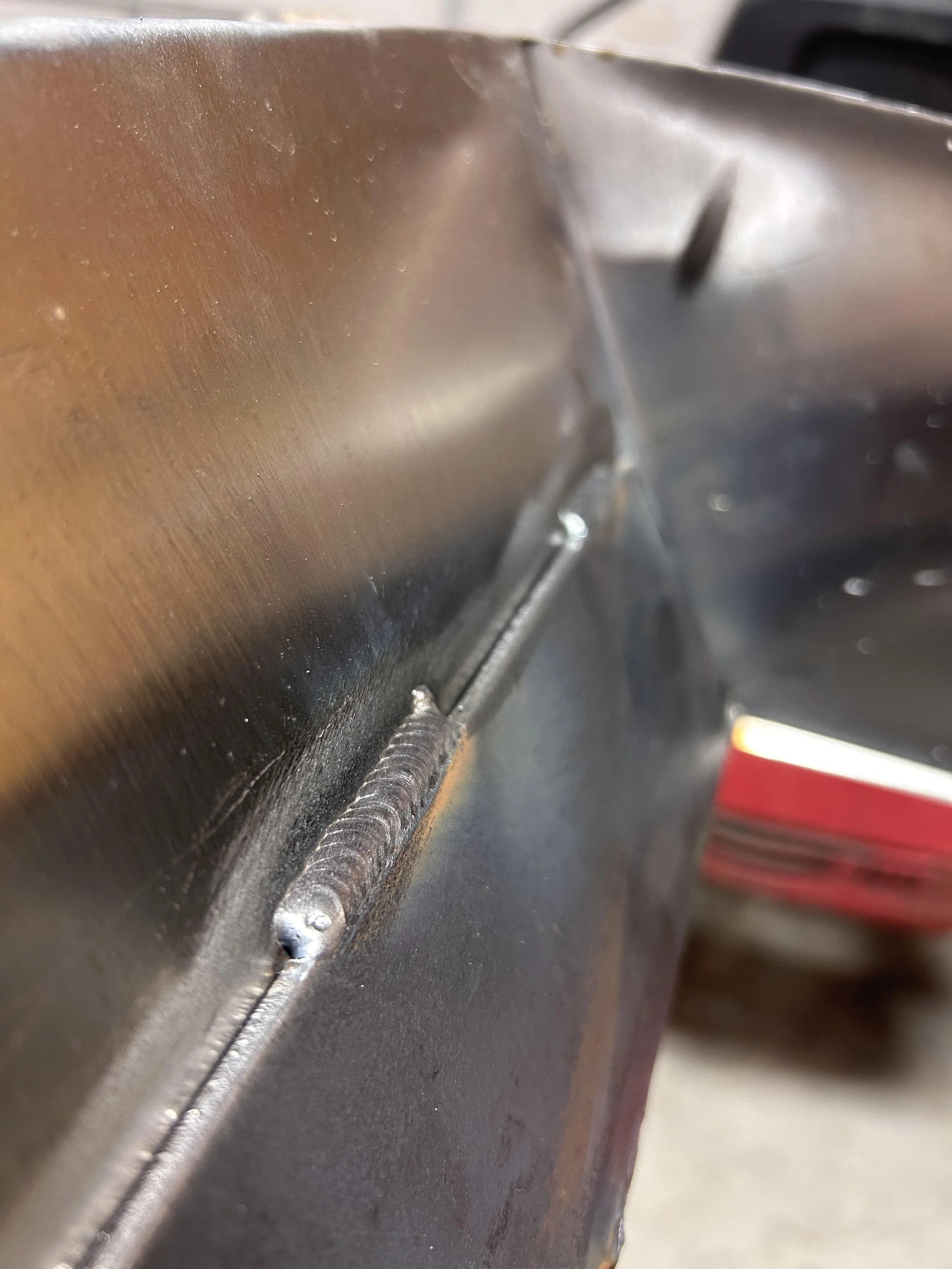 Close-up of a metal surface with a weld seam. Quality structural compliant welds. Mig welding process.