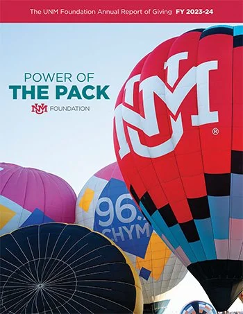 Hot air balloons with various designs, featuring a prominent one with the UNM logo, against a clear sky backdrop. Text reads "Power of the Pack" with UNM Foundation branding and "The UNM Foundation Annual Report of Giving FY 2023-24" at the top.