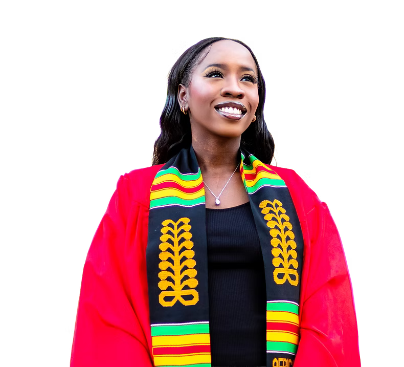 Woman dressed in graduation gown with a colorful Kente stole, smiling and looking upward.