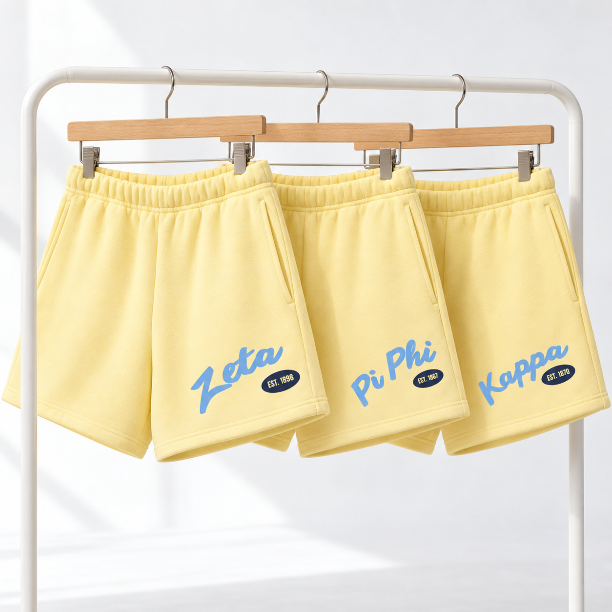 Three butter yellow collegiate sweat shorts.png