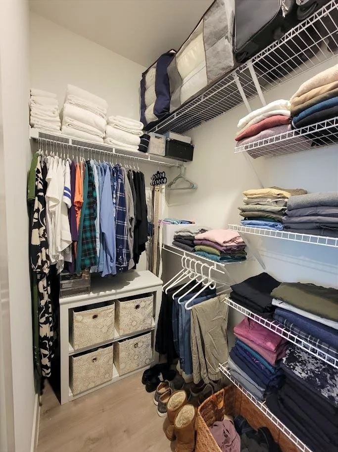 Her side of organized primary closet. Client downsized from 2000+sf to 1000 sf. 