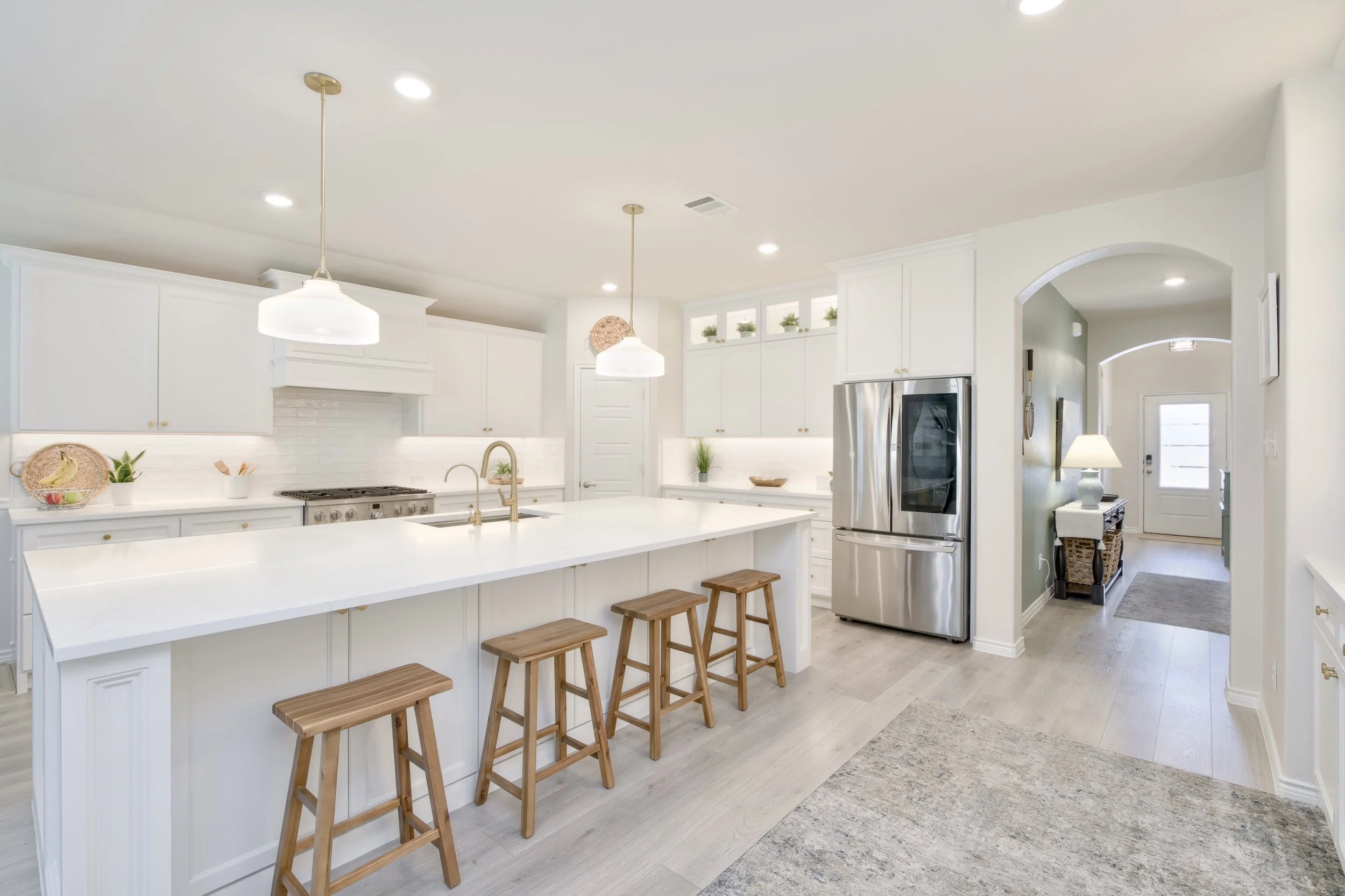 Kitchen island features seating for up to 5; backside of island has tons of additional storage with 3 sets of large cabinets with adjustable shelves to store larger items. Refrigerator cabinet was designed for a counter-depth fridge (fridge shown is 