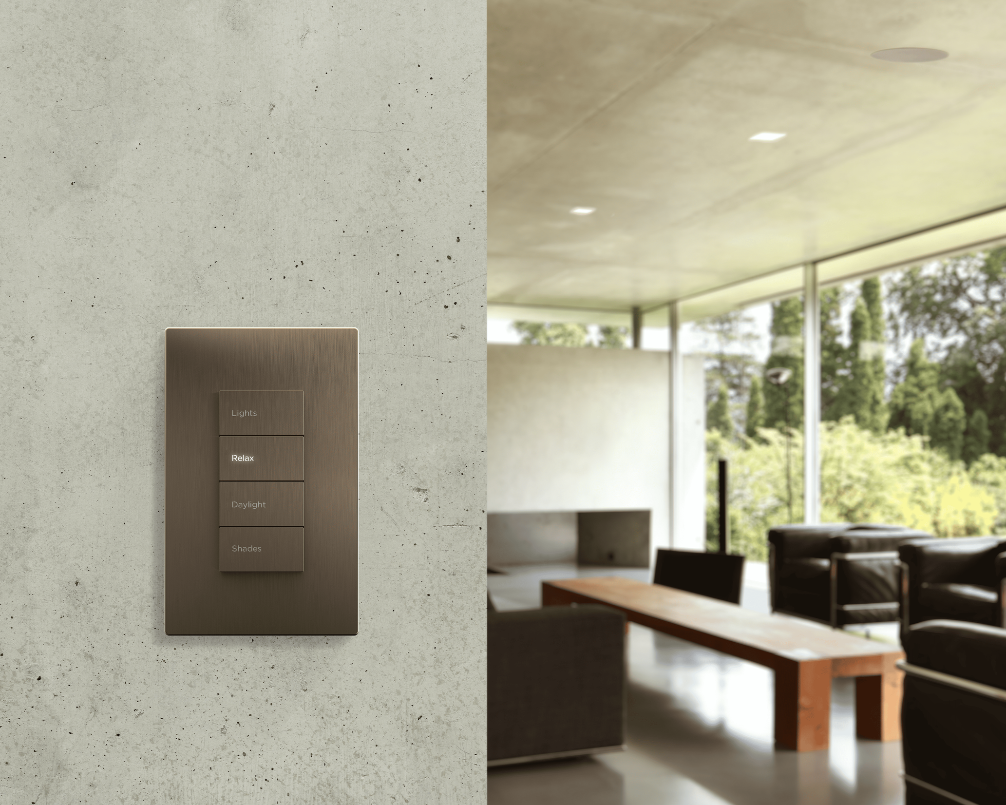 Modern living room with wall-mounted smart home control panel for lights, shades, and scenes, overlooking greenery outside