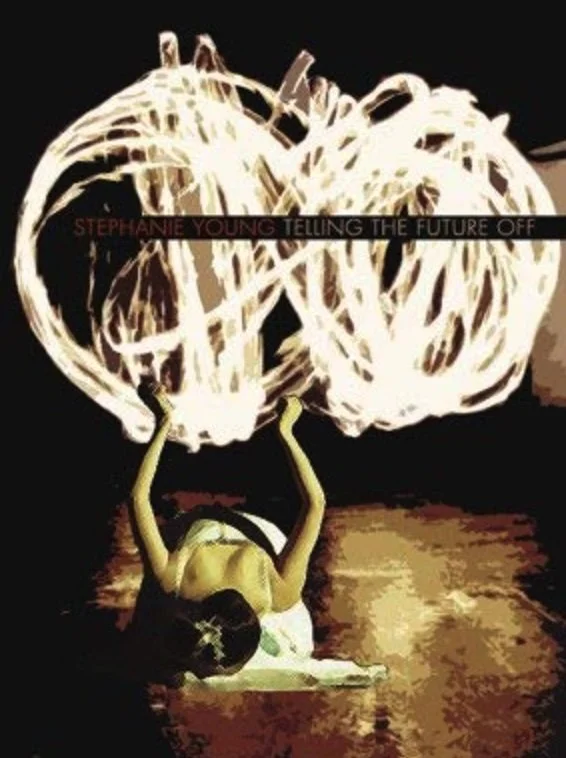 Book cover titled "Telling the Future Off" by Stephanie Young depicting a woman lying on the ground, her arms raised above her head, with large illuminated neon circles in the background. The woman is prostrate before the neon.