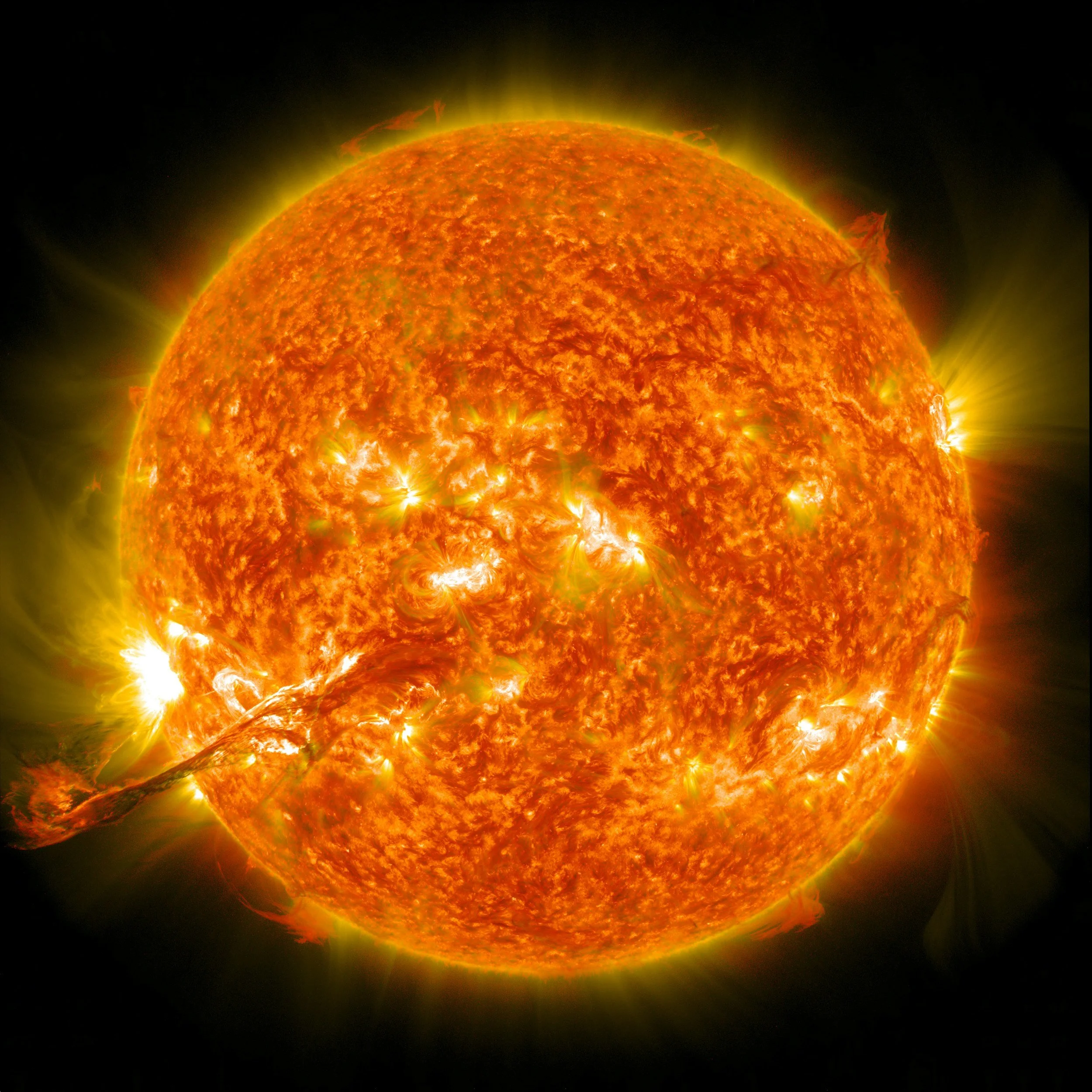 A detailed image of the sun showing solar flares and prominences with a bright, fiery surface.