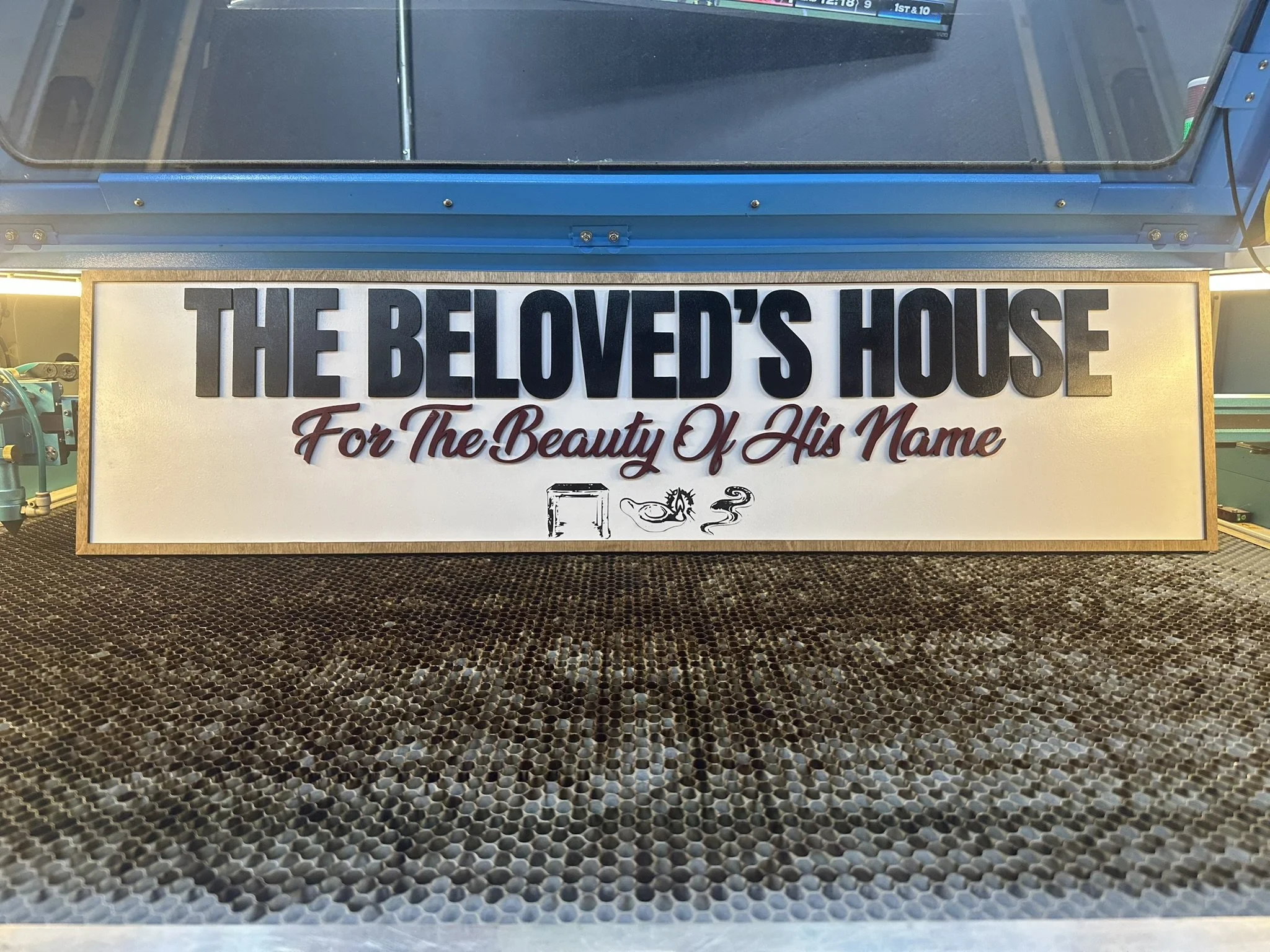 A sign for 'The Beloved's House' with the subtitle 'For The Beauty Of His Name'.