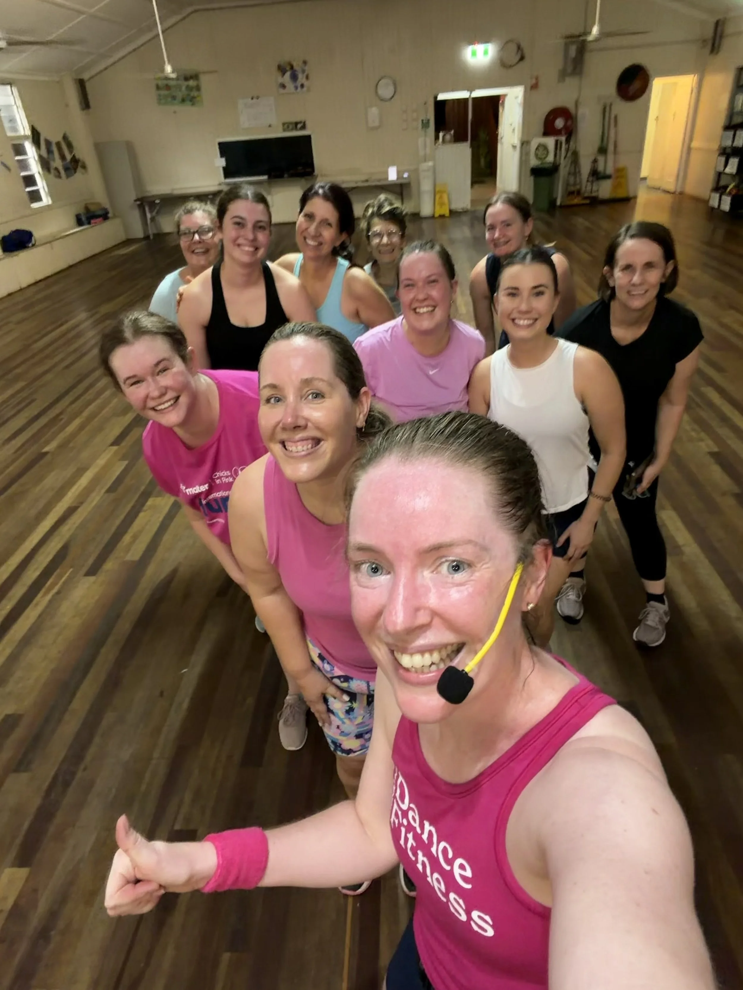 group of women in activewear looking happy and sweaty