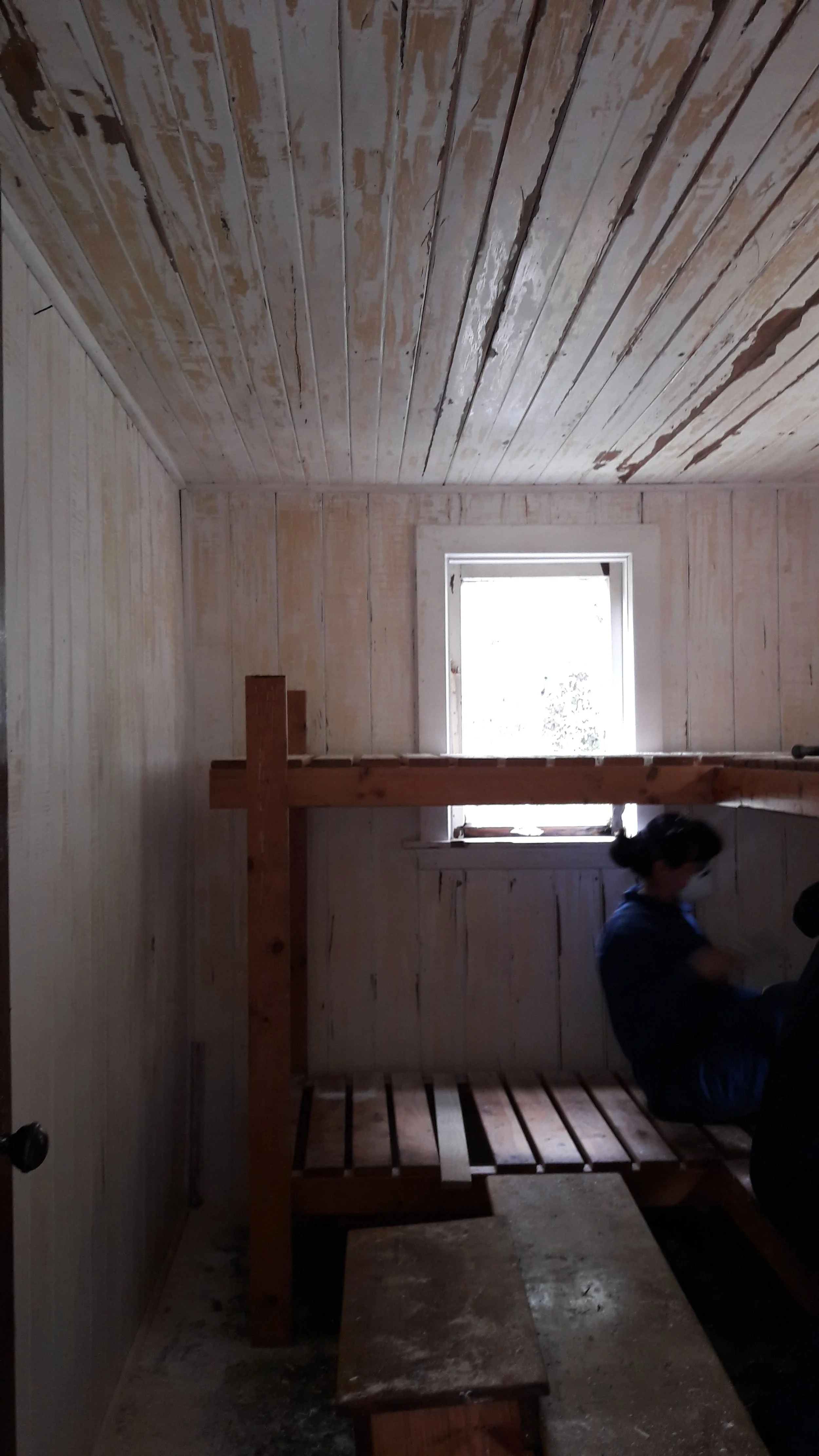 15 April - Tania scraping bunkroom walls in preparation for priming and painting.jpg