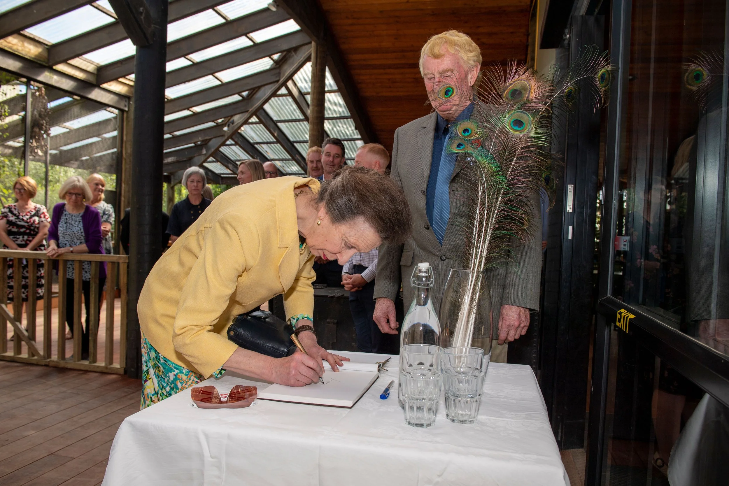 Princess Anne signing visitors book.jpeg
