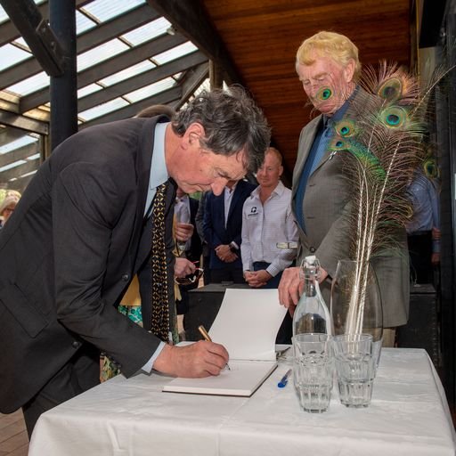 Sir Tim signing visitors book.jpeg