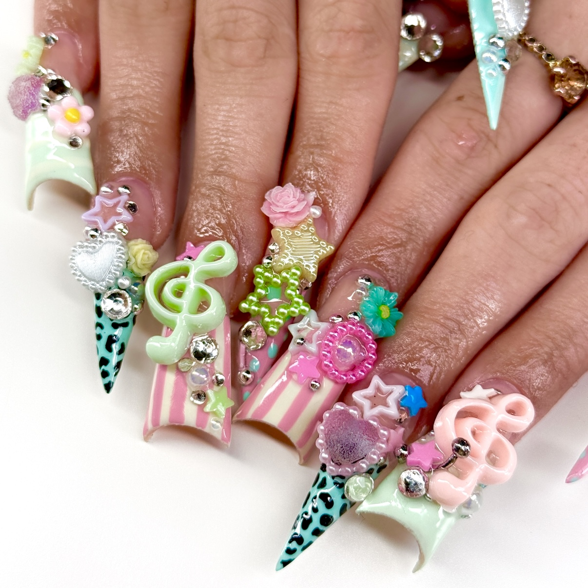 Colorful long stiletto and duck nails with charms