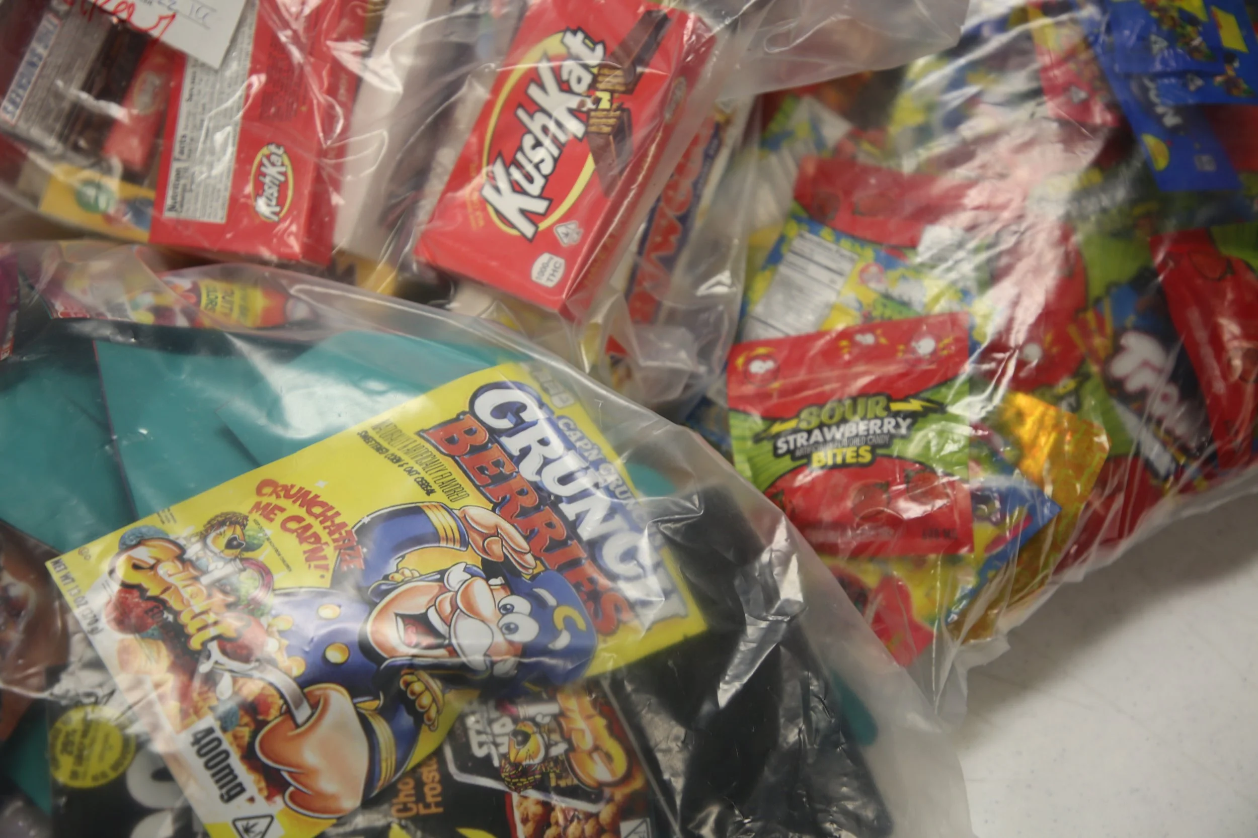 Various packages of Sour Punch candies in a clear plastic bag, including sour strawberry bites and other sour gummy candies.