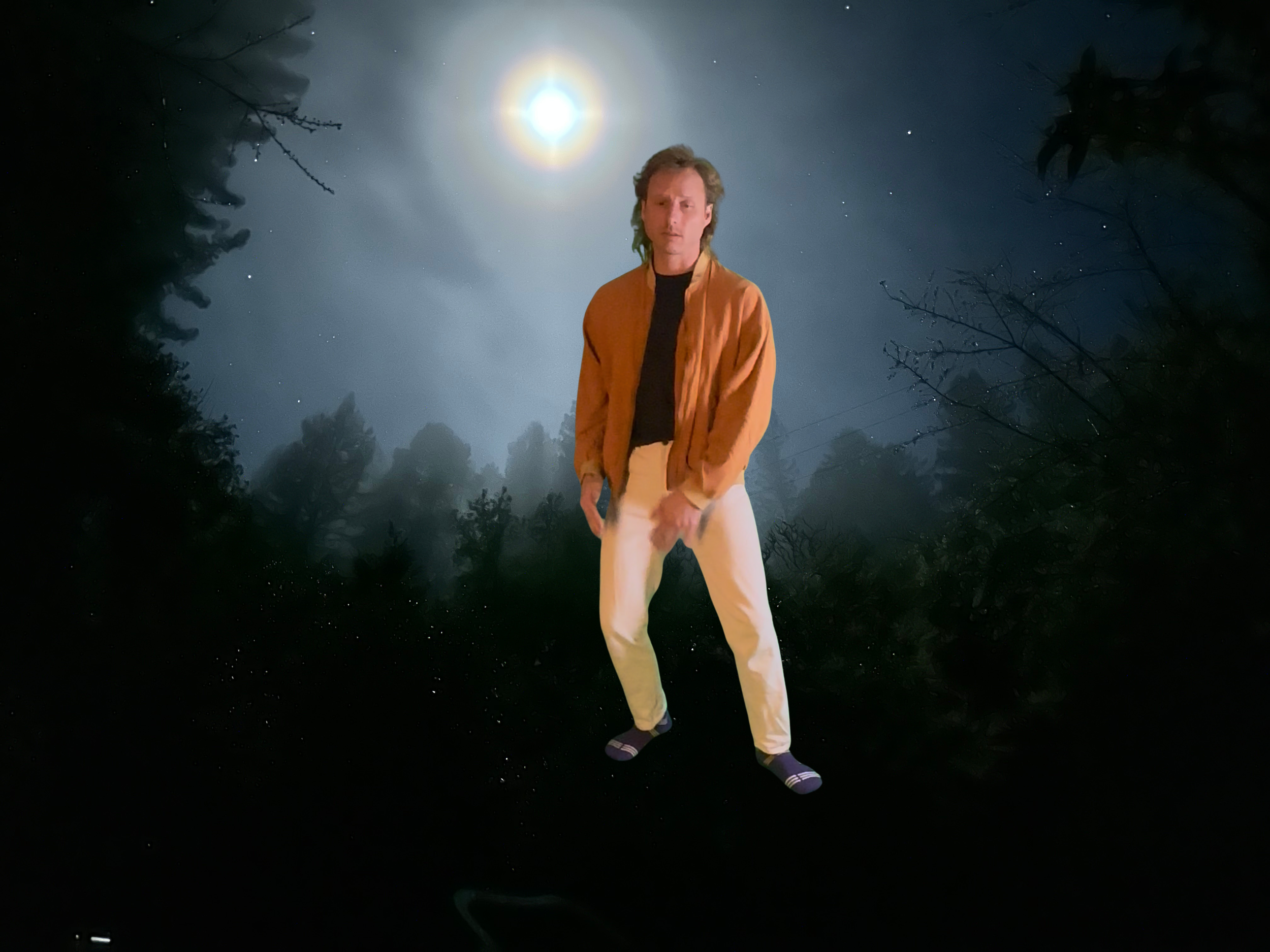 Muunjuun standing outdoors at night under a bright full moon, surrounded by trees and starry sky, wearing a brown jacket, black shirt, white pants, and striped socks.