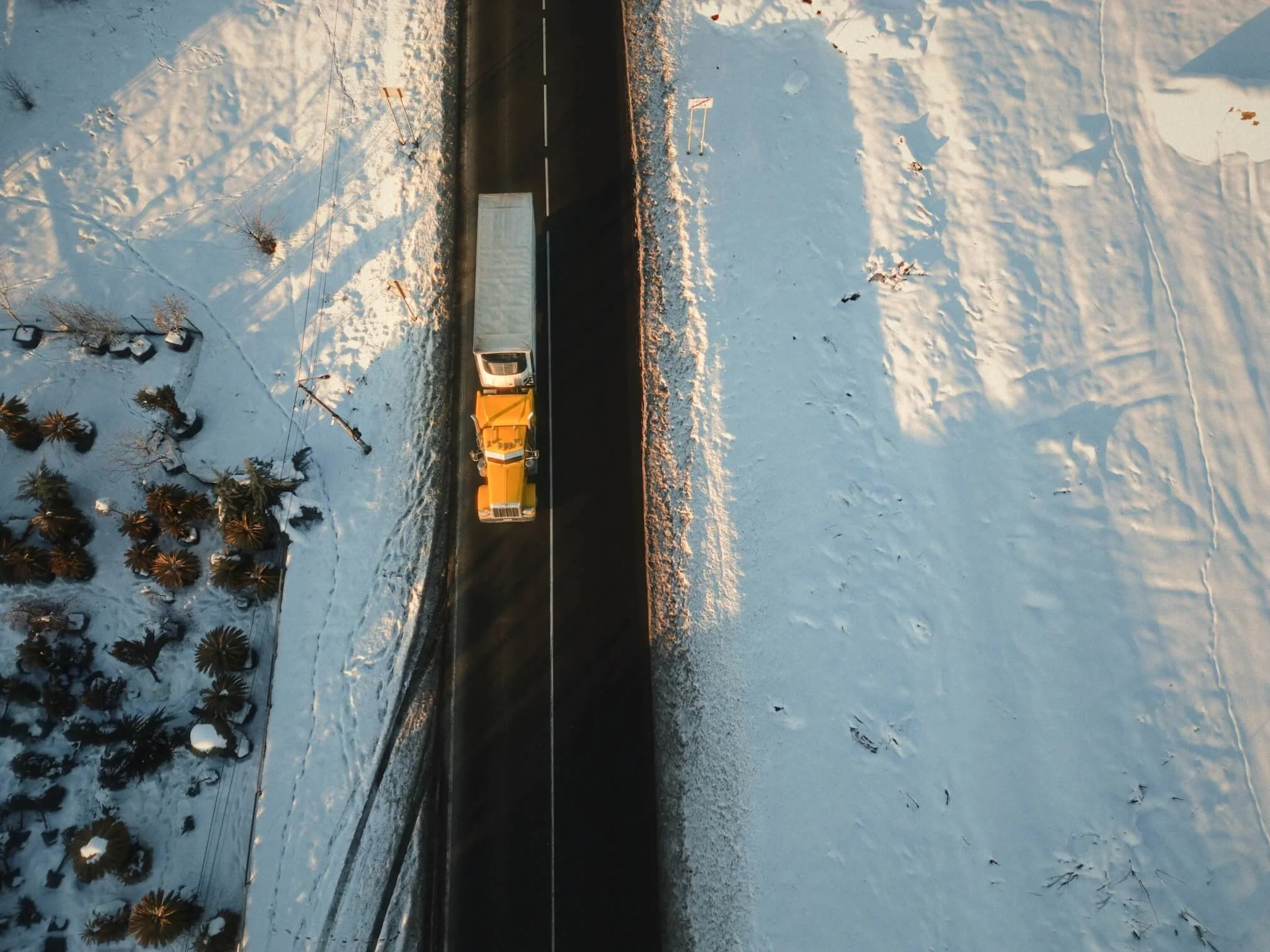 A long-haul trucker on a street lined with snow