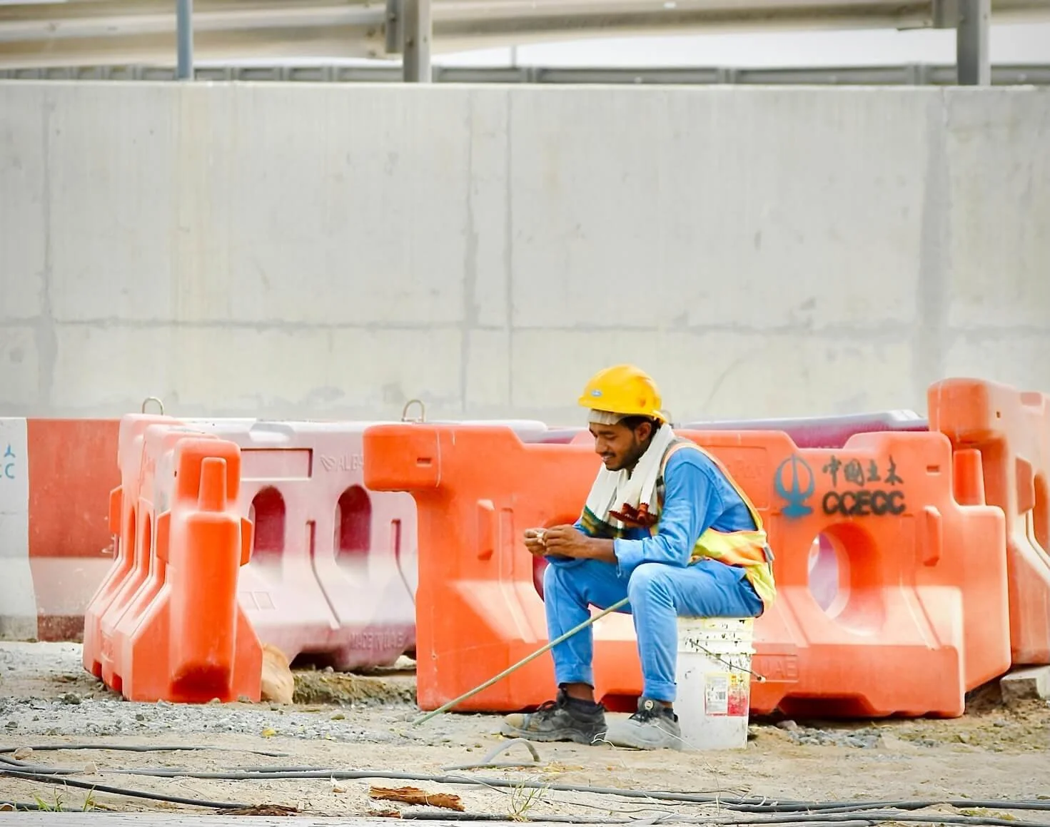 A worker sits on a construction site