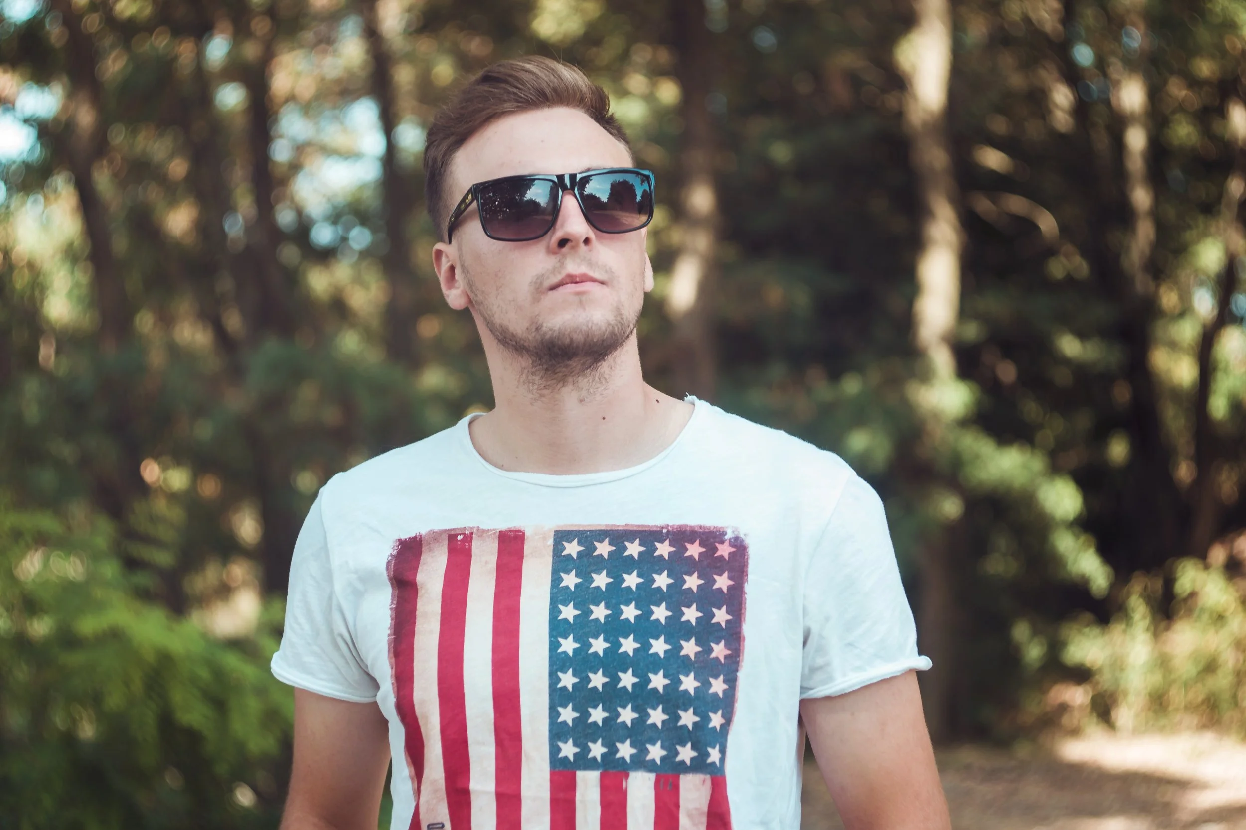 portrait-stylish-young-man-t-shirt-with-american-flag-student-park.jpg