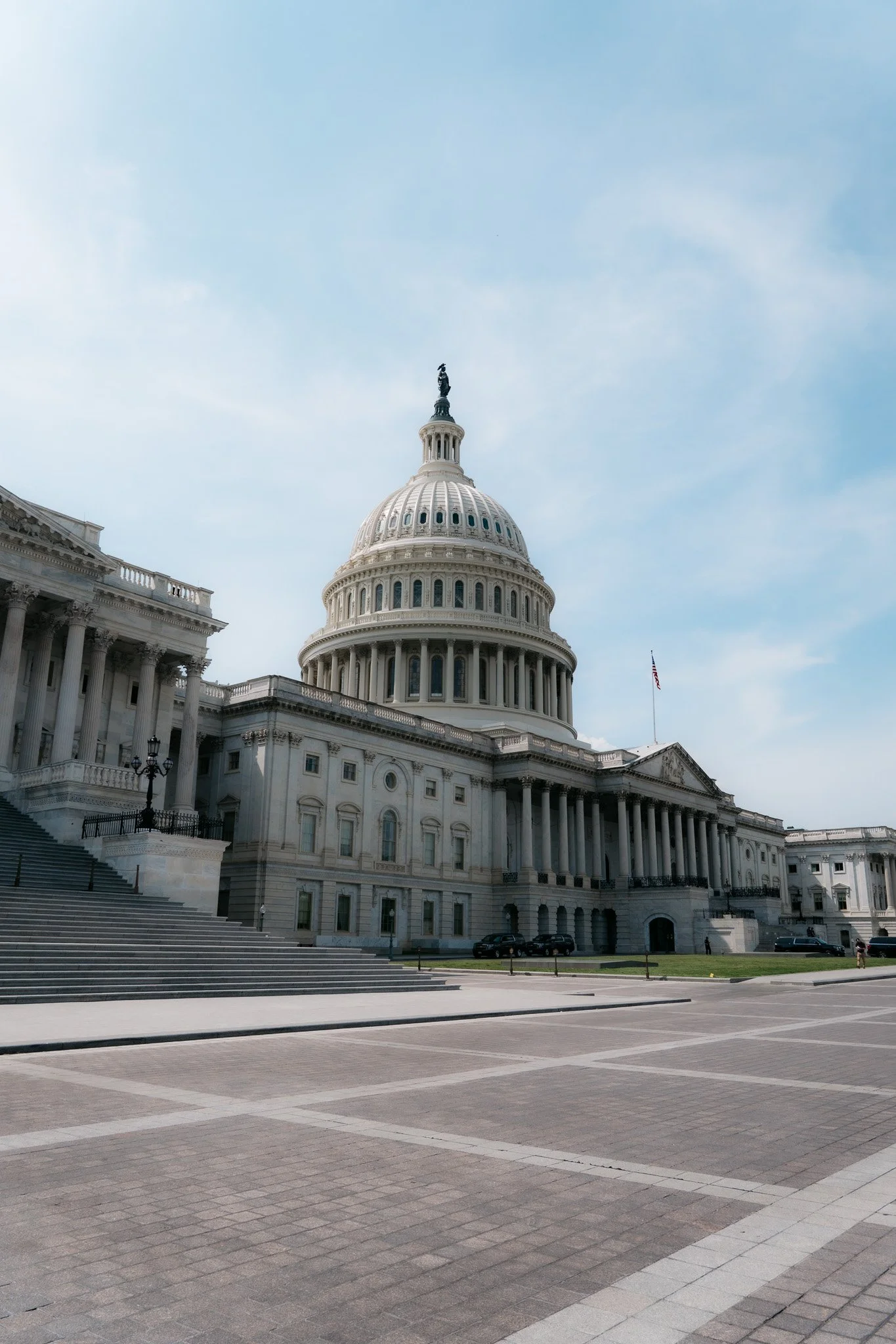 The United States Capitol building with a partly cloudy sky.