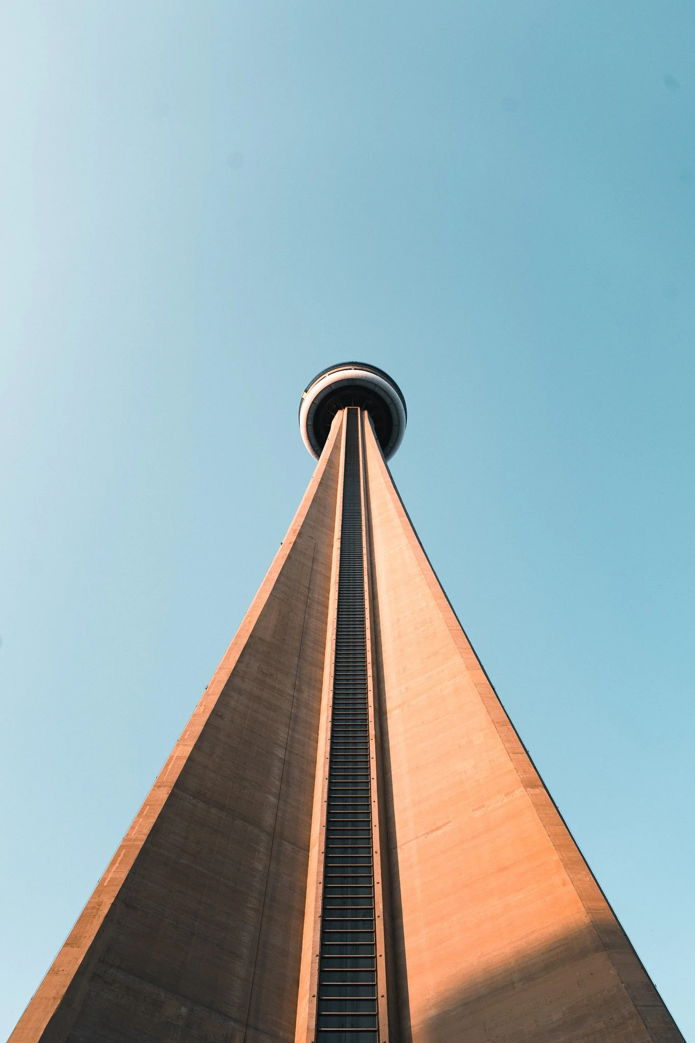 A tall observation tower viewed from the base looking upward toward the sky.