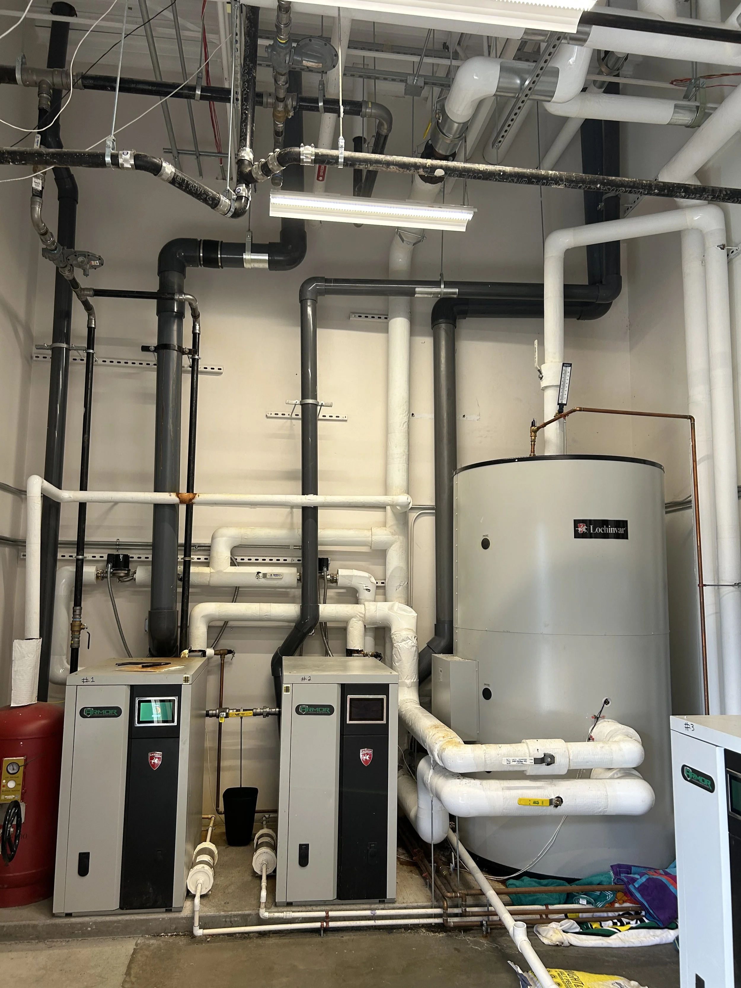 Mechanical equipment and piping system in an industrial / Commercial facility plumbing maintenance, gas line pressure testing, and multi-unit water heater installation in the Dallas area.