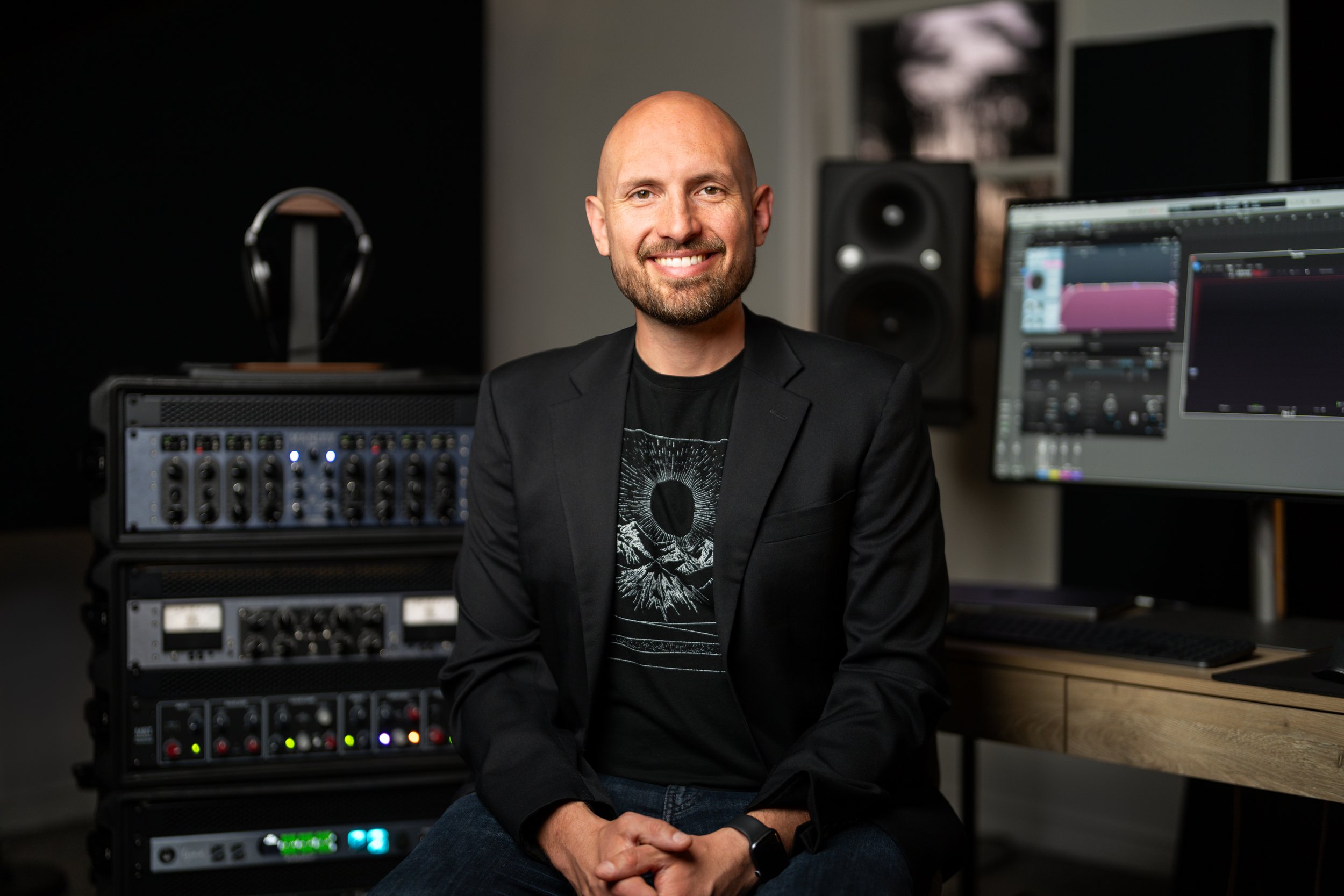 Jonathan Davidson, an audio mastering engineer, sits in his studio surrounded by analogue mastering hardware.