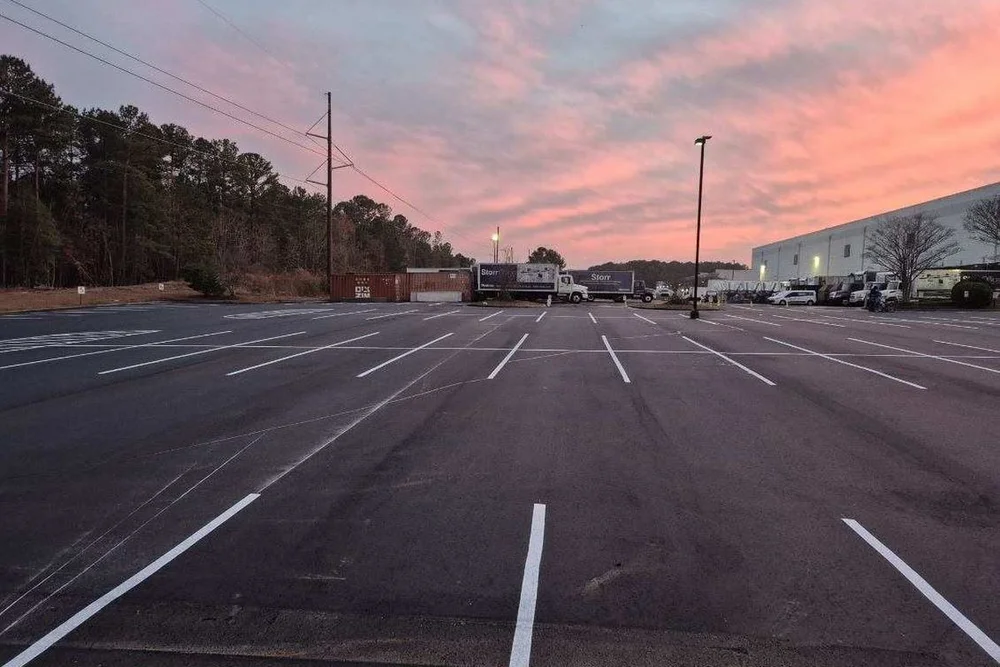 Freshly sealed and striped warehouse parking lot in Morrisville, NC
