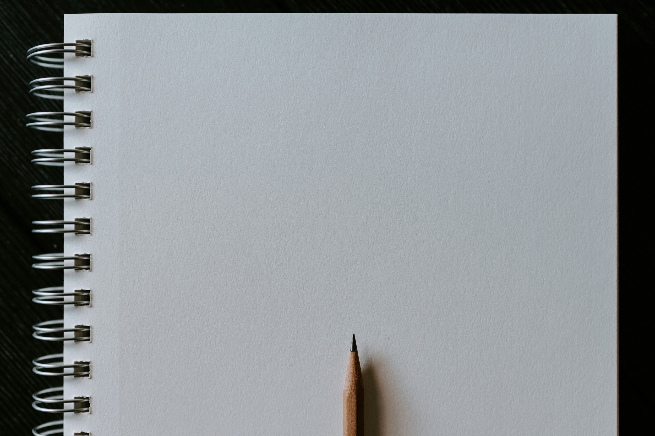Photo by Kelly Sikkema, Upsplash, Image of a pencil on blank page.