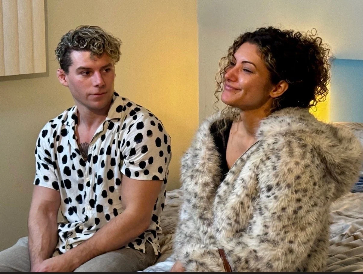 Travis acting listening to a musing woman